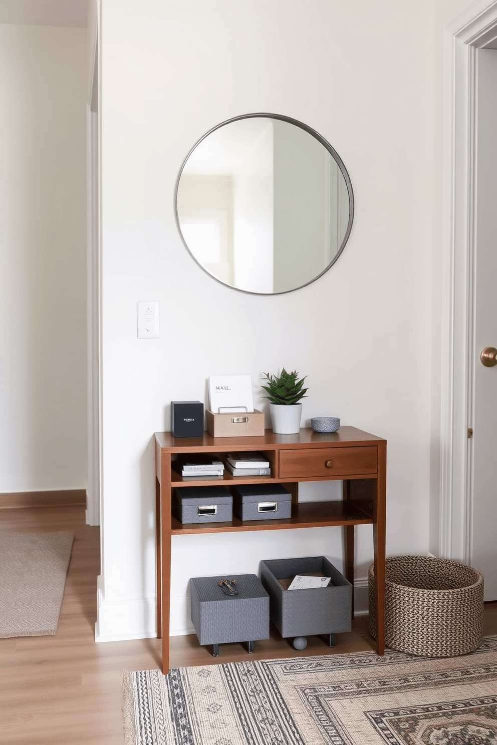 A small table designed for mail organization sits against the wall of a stylish apartment entryway. The table features a sleek wood finish, complemented by decorative storage boxes and a small potted plant on top. Above the table, a round mirror with a minimalist frame reflects the space, enhancing its brightness. The walls are painted in a soft, neutral tone, and a textured rug adds warmth to the entryway floor.