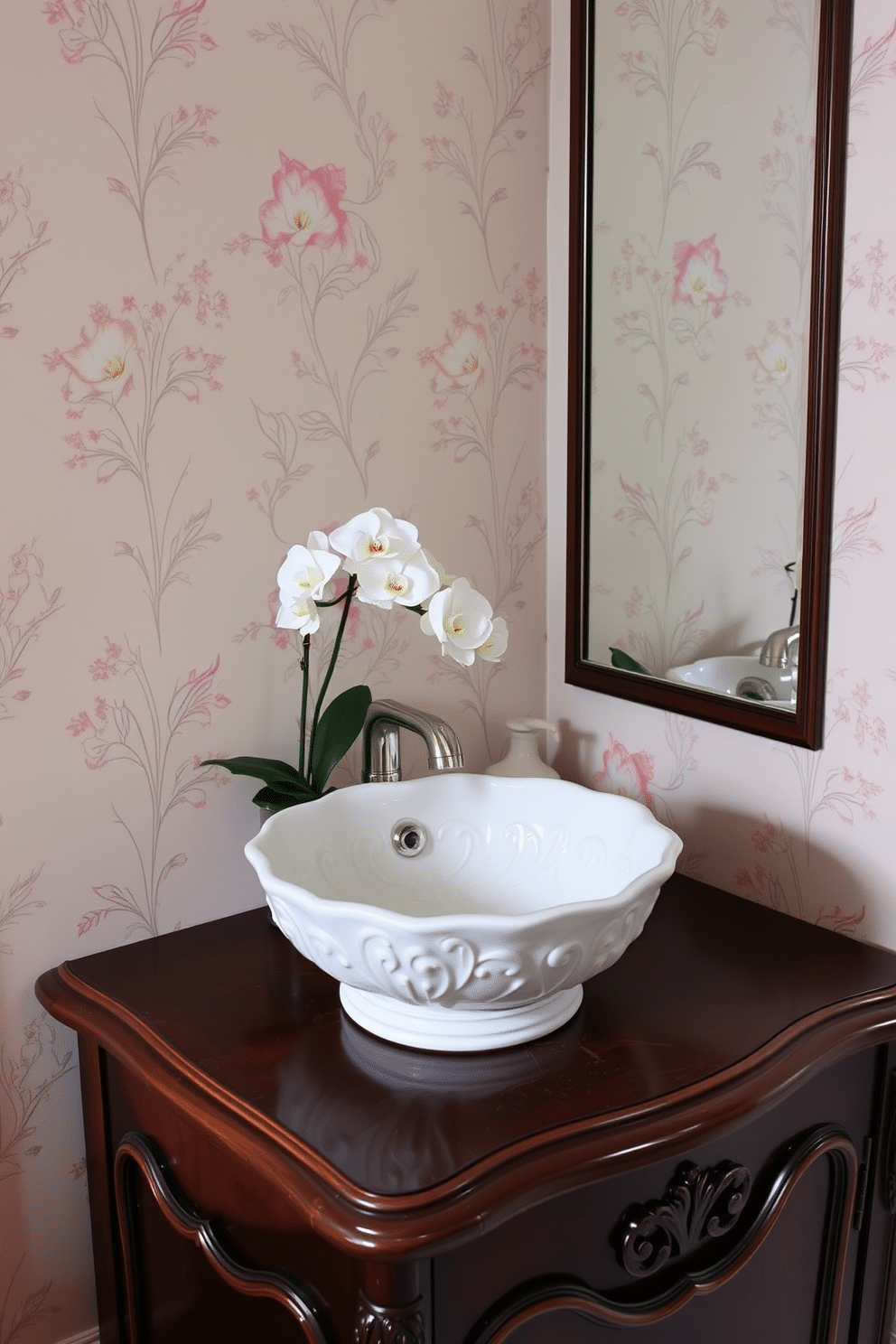 Elegant porcelain sink with intricate details. The sink is complemented by a sleek, dark wood vanity that features delicate carvings and a polished surface. The walls are adorned with subtle floral wallpaper in soft pastels, creating a serene atmosphere. A small potted orchid sits on the vanity, adding a touch of natural beauty to the space.