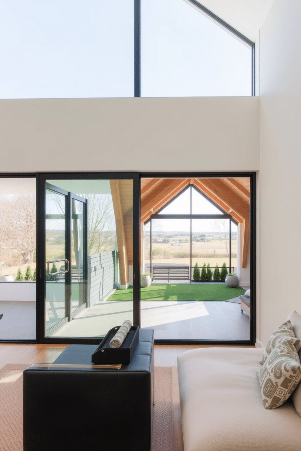 A modern living space featuring sliding glass doors that seamlessly connect the indoor area to a spacious outdoor patio. The doors are framed with sleek black aluminum, allowing natural light to flood the room and providing unobstructed views of the garden. A cozy attic room with a large window that offers a panoramic view of the surrounding landscape. The design incorporates exposed wooden beams and soft, ambient lighting to create a warm and inviting atmosphere.