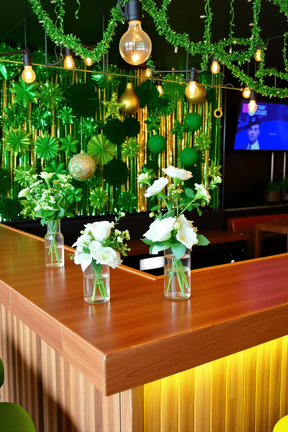 A vibrant bar area designed for St. Patrick's Day, featuring a sleek wooden bar counter adorned with green and white flowers in elegant vases. The backdrop showcases a wall of shimmering green and gold decorations, while festive string lights illuminate the space, creating a warm and inviting ambiance.