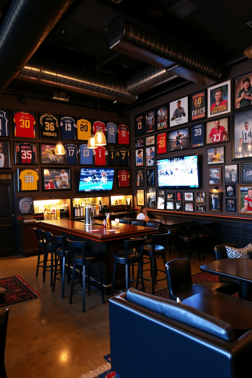 A lively sports-themed bar featuring an array of memorabilia displays, including framed jerseys and signed photographs adorning the walls. The bar itself is made of dark wood, with high-top stools and a polished countertop, illuminated by pendant lights that cast a warm glow. In one corner, a large flat-screen TV is mounted for game nights, surrounded by comfortable seating that encourages socializing. The flooring is a mix of polished concrete and area rugs, while the color scheme incorporates team colors for a vibrant atmosphere.