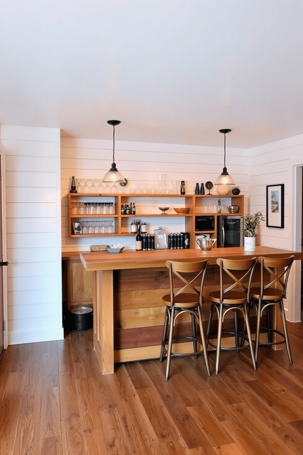 A charming farmhouse-style bar features shiplap walls painted in a soft white, creating a cozy and inviting atmosphere. The bar itself is crafted from reclaimed wood, with a rustic countertop and vintage bar stools that add character to the space. Behind the bar, open shelving showcases an array of glassware and decorative items, while warm pendant lights hang overhead, illuminating the area. The floor is finished with distressed hardwood, complementing the overall farmhouse aesthetic and enhancing the cozy vibe of the basement bar.