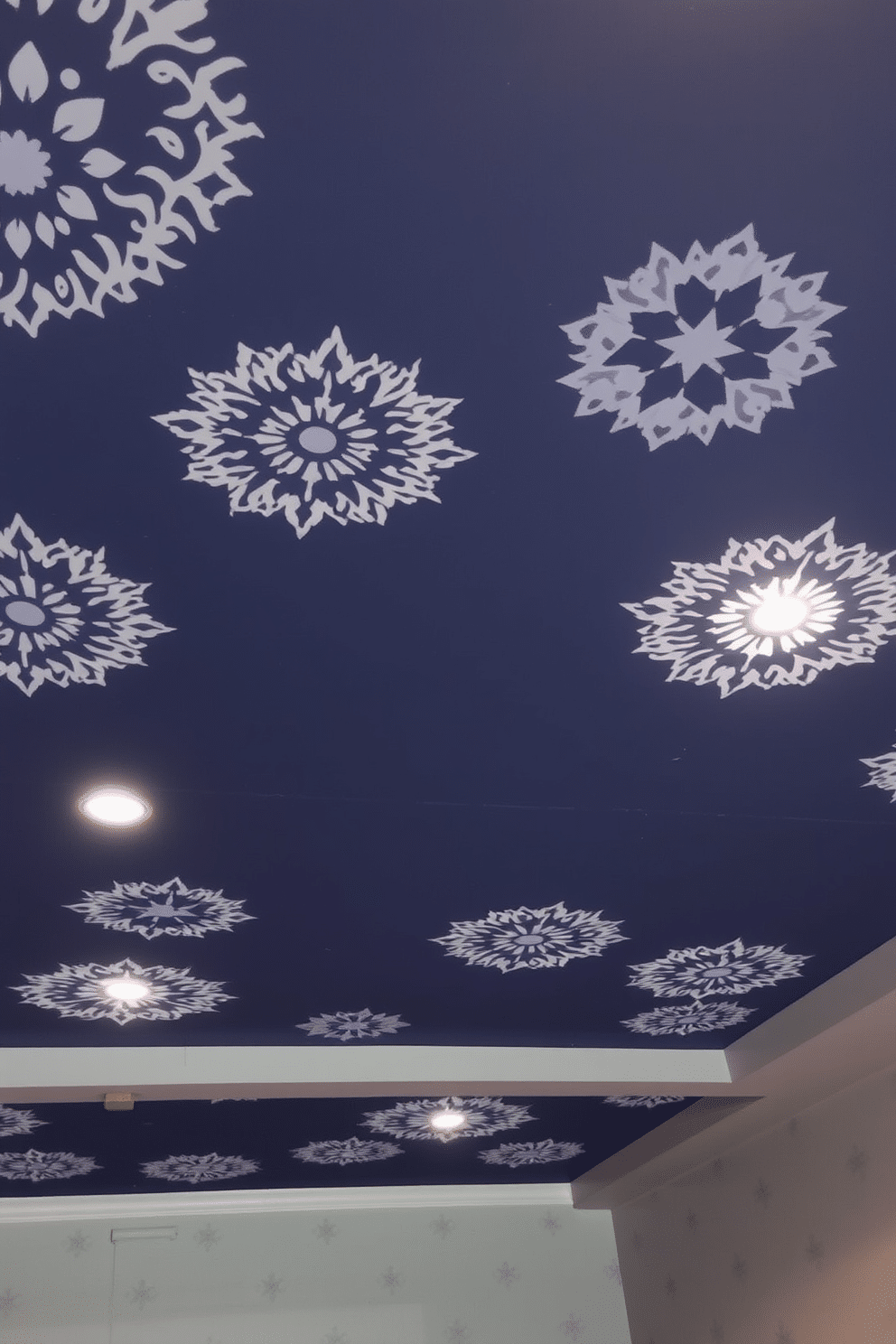 A basement ceiling featuring intricate stenciled designs that add artistic flair to the space. The ceiling is painted in a deep navy blue, with white stencils of geometric patterns creating a striking contrast. Soft ambient lighting is integrated into the design, highlighting the stenciled patterns and enhancing the overall atmosphere. The walls are a light gray, providing a modern backdrop that complements the ceiling's artistic elements.