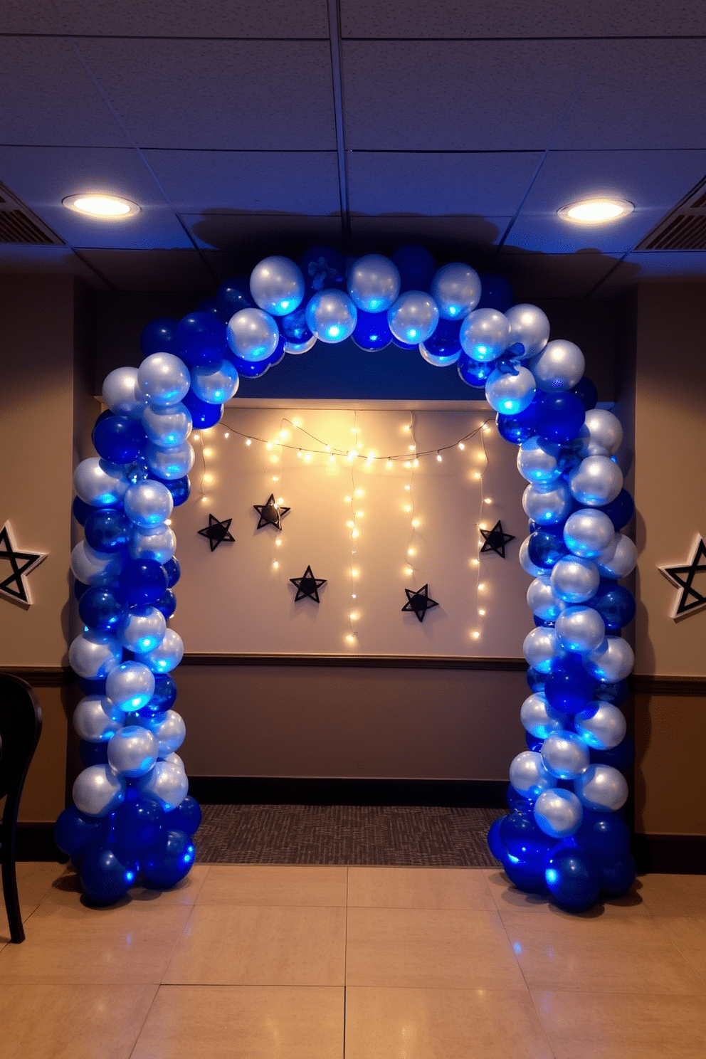 A festive basement setting adorned with a stunning silver and blue balloon arch that elegantly frames the entrance. The walls are decorated with subtle Hanukkah-themed decor, including stars of David and shimmering string lights, creating a warm and inviting atmosphere for celebration.