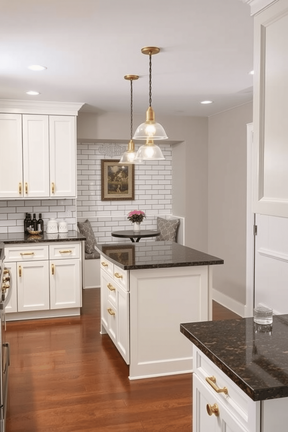 A basement kitchen featuring a subway tile backsplash that adds a classic appeal. The cabinetry is painted in a soft white, complemented by brass hardware, while the countertops are a rich, dark granite that contrasts beautifully with the light tiles. The space is illuminated by pendant lights hanging over a central island, which includes bar seating for casual dining. A cozy seating nook with a small table is tucked into one corner, creating an inviting atmosphere for family gatherings.