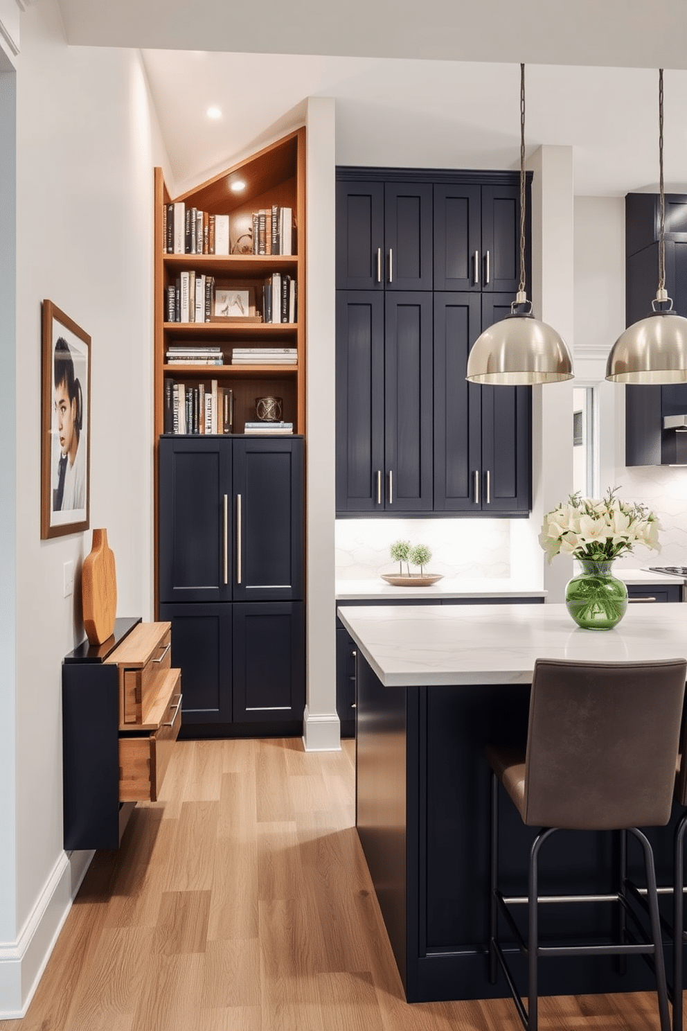 Smart storage solutions under the stairs. A sleek, custom-built cabinet fits seamlessly into the stairwell, utilizing the vertical space for books and decorative items. The design features pull-out drawers and open shelving, all finished in a warm wood tone that complements the home's overall aesthetic. Basement kitchen design ideas. The kitchen boasts a modern layout with an island at its center, surrounded by stylish bar stools. Sleek cabinetry in a deep navy blue contrasts beautifully with the light marble countertops, while ambient lighting highlights the space's functional yet inviting atmosphere.