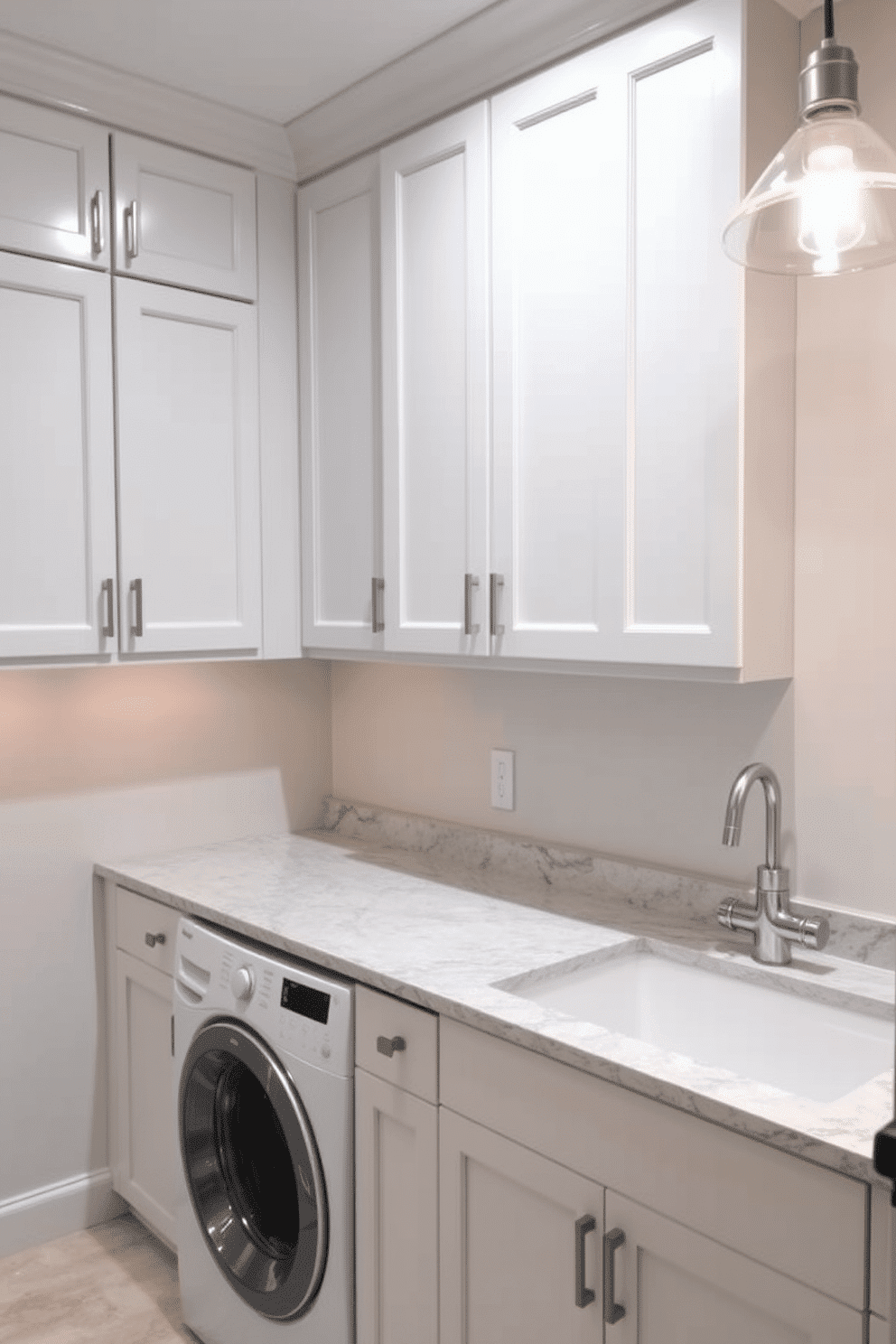 A functional folding station is integrated into the basement laundry room, featuring a spacious countertop made of durable quartz. The area is designed with ample storage cabinets above and below, providing easy access to laundry essentials while maintaining a clean and organized look. The walls are painted in a soft, light gray to enhance brightness, complemented by stylish pendant lighting that adds warmth. A large, practical sink is situated beside the folding station, making it convenient for pre-treating clothes and handling laundry tasks efficiently.