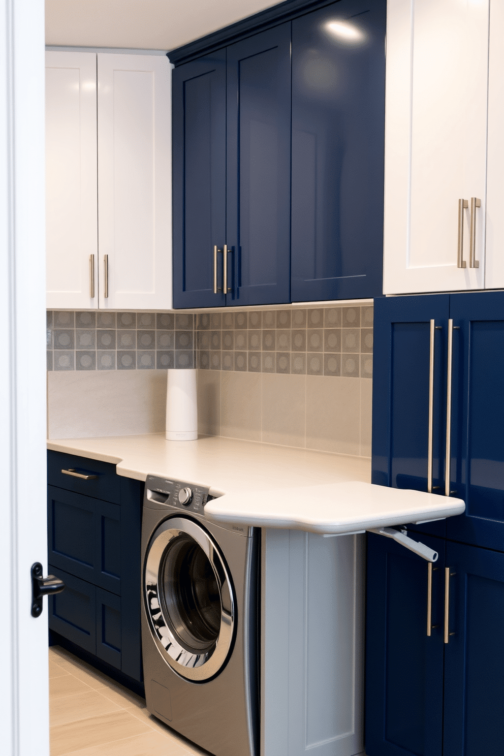 A stylish laundry room that incorporates a pull-out ironing board feature. The space includes a sleek cabinetry design with a combination of white and navy blue finishes, providing ample storage and a modern aesthetic. The ironing board is seamlessly integrated into the cabinetry, allowing it to be easily pulled out when needed. The room features a practical layout with a washer and dryer stacked for efficiency, complemented by a chic backsplash in a soft gray tile.