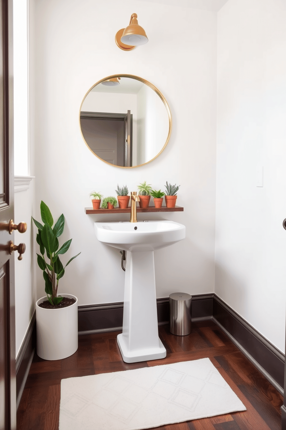 A charming powder room adorned with small potted plants that add a refreshing natural touch. The walls are painted in a soft, neutral tone, complemented by a sleek white pedestal sink and a round mirror framed in brushed gold. The floor features elegant, dark hardwood that contrasts beautifully with the light colors of the room. On a floating shelf above the sink, several small potted plants are arranged, bringing life and vibrancy to the space.