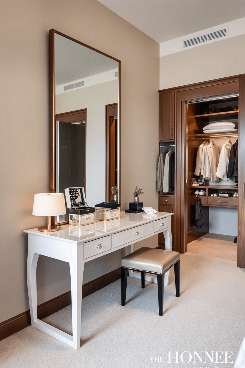 A luxurious dressing table is positioned against a wall, featuring an expansive mirror that reflects natural light and enhances the room's spacious feel. The table is adorned with elegant accessories, including a stylish jewelry box and a chic table lamp, creating a sophisticated yet functional space. The walk-in closet is designed with custom shelving and hanging space, allowing for organized storage of clothing and accessories. Soft, ambient lighting highlights the rich wood finishes and plush carpet, creating an inviting atmosphere for selecting outfits.