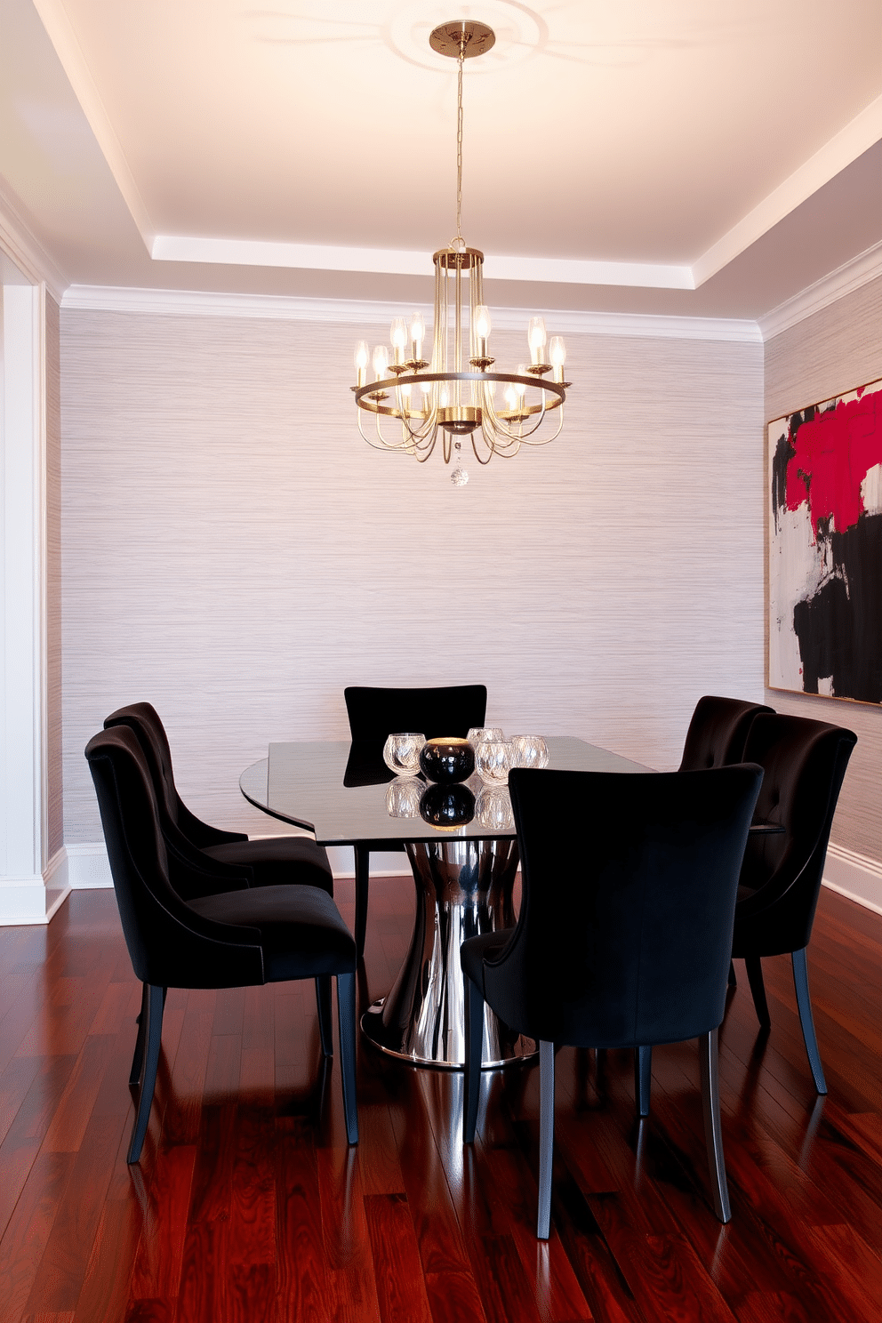 A chic dining room featuring elegant black velvet dining chairs around a sleek, glass-top table. The walls are adorned with soft gray wallpaper, and a modern chandelier hangs above, casting a warm glow over the space. The floor is finished in rich hardwood, complementing the luxurious texture of the chairs. A large piece of abstract art in bold colors is displayed on one wall, adding a vibrant focal point to the sophisticated ambiance.