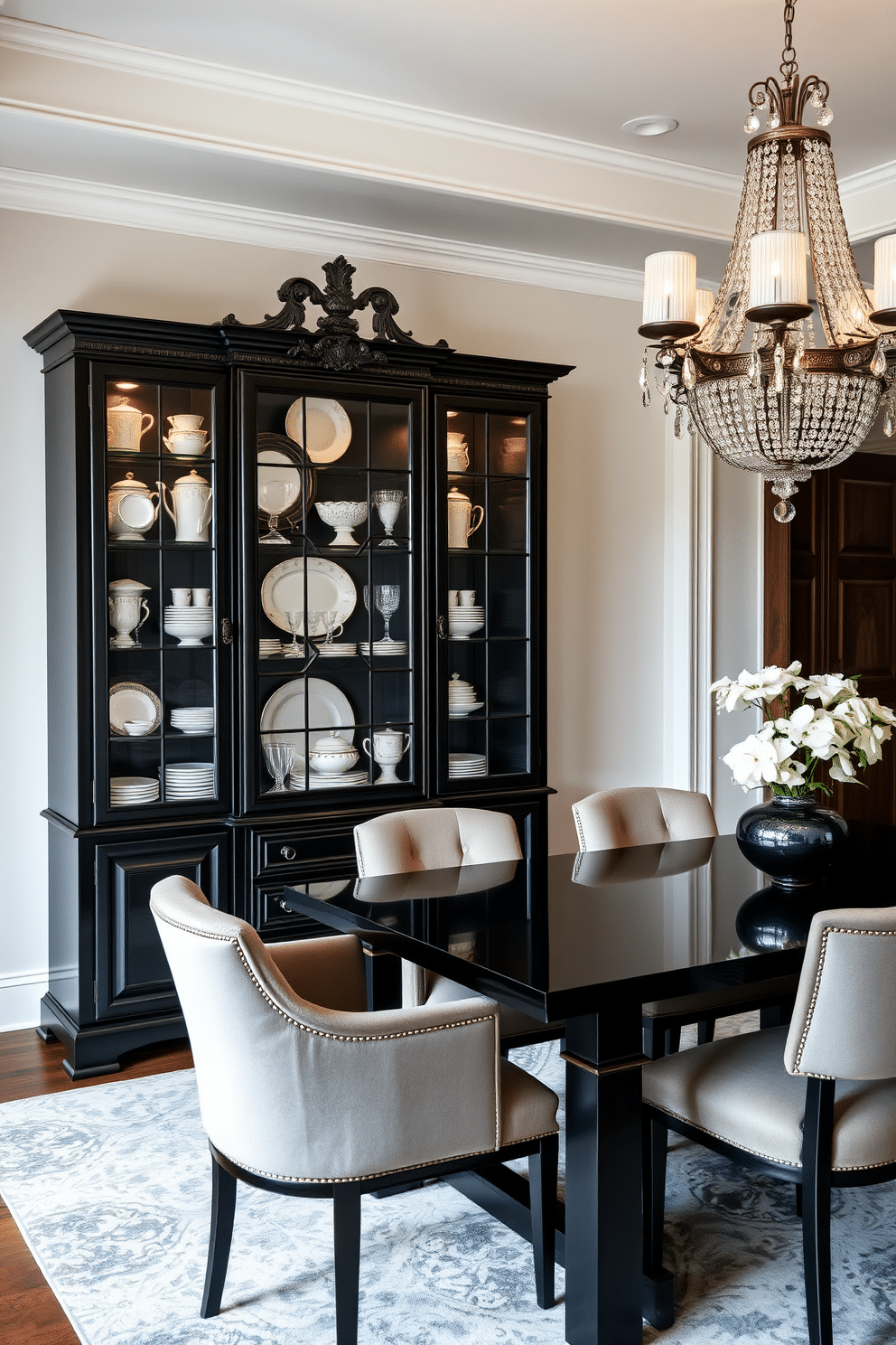 A sophisticated black china cabinet stands against the wall, showcasing an elegant collection of fine china and glassware. The cabinet features intricate detailing and is illuminated by soft, warm lighting that highlights the exquisite pieces within. The dining room is adorned with a sleek black dining table surrounded by plush upholstered chairs in a contrasting color. A striking chandelier hangs above, casting a gentle glow over the space, while rich, dark wood accents add depth and warmth to the overall design.