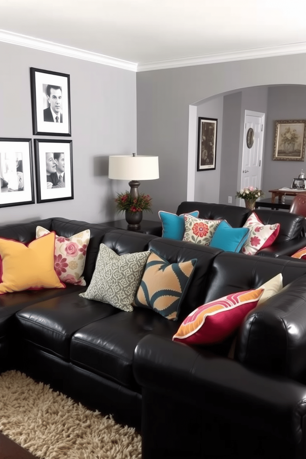 A cozy black leather couch is the centerpiece of the family room, adorned with an array of colorful pillows that add a vibrant touch. The walls are painted in a soft gray, and a plush area rug anchors the seating arrangement, creating an inviting atmosphere for relaxation and gatherings.