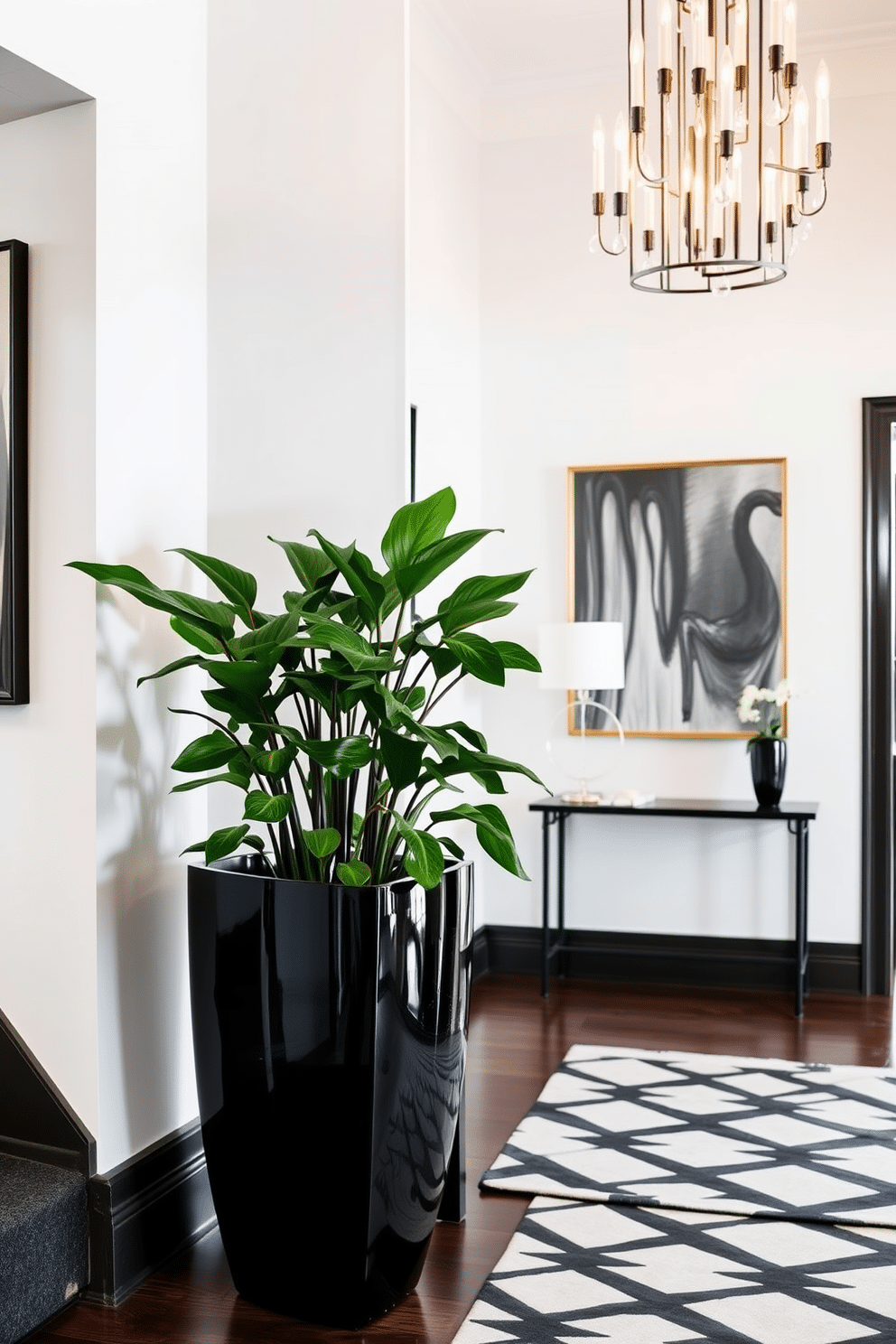 A striking black planter sits in the corner of a stylish foyer, showcasing lush greenery that adds a touch of life to the space. The walls are adorned with elegant artwork, and a sleek console table complements the planter, creating a harmonious entryway. The foyer features a bold black and white color scheme, with a geometric patterned rug anchoring the area. Soft lighting from a modern chandelier casts a warm glow, enhancing the inviting atmosphere of this sophisticated entrance.