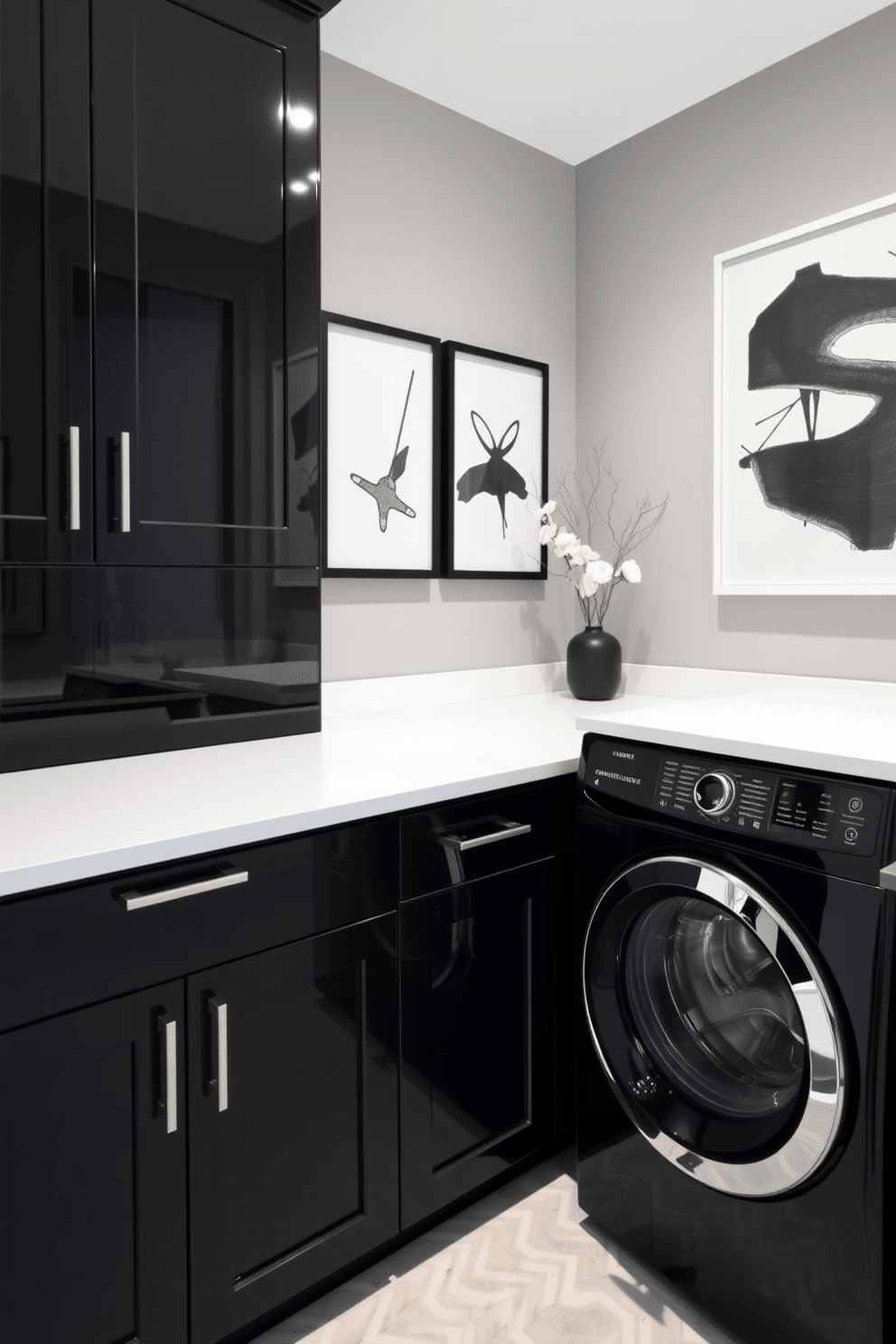 A stylish black laundry room features sleek cabinetry with a glossy finish, complemented by a white countertop that provides ample workspace. The walls are adorned with contemporary black and white artwork, adding a touch of sophistication to the space while maintaining a clean and modern aesthetic.