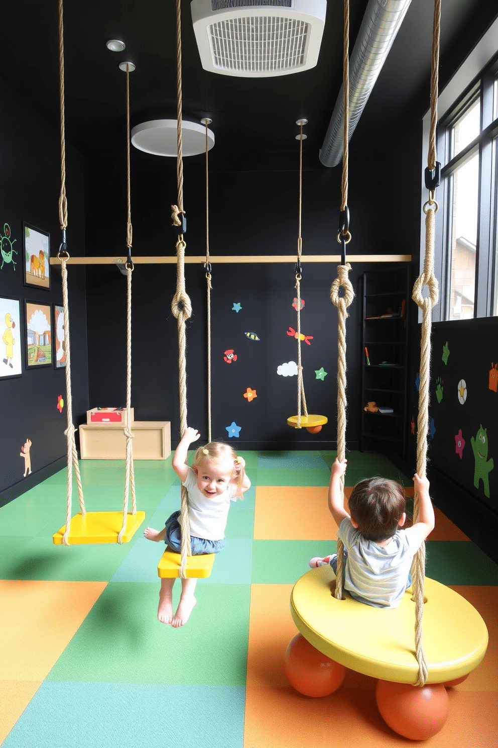 A vibrant playroom filled with energy, featuring hanging swings suspended from the ceiling, inviting children to engage in active play. The walls are painted in a bold black hue, accented with colorful artwork and playful decals that stimulate creativity and imagination.