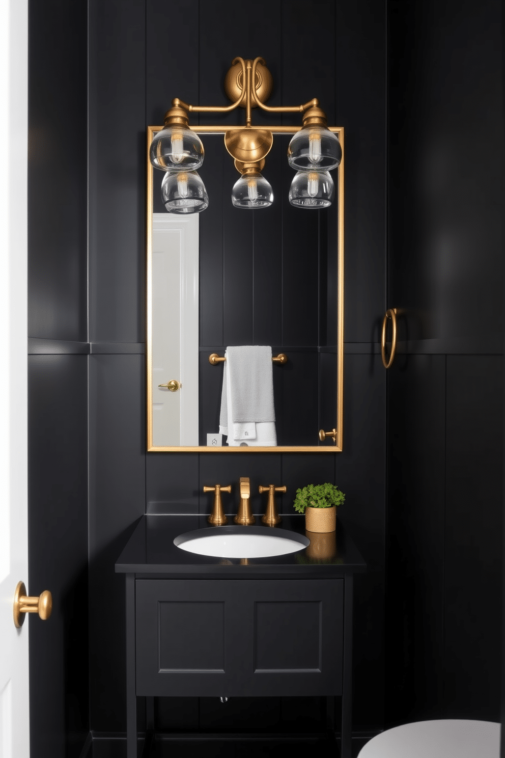 A striking black powder room features sleek black walls that create a dramatic backdrop. Accents of brass, including a chic faucet and decorative light fixtures, add a touch of elegance and sophistication. The vanity showcases a minimalist design with a black countertop and a brass-framed mirror above. A stylish brass towel holder complements the overall aesthetic, while a small potted plant adds a hint of greenery to the space.