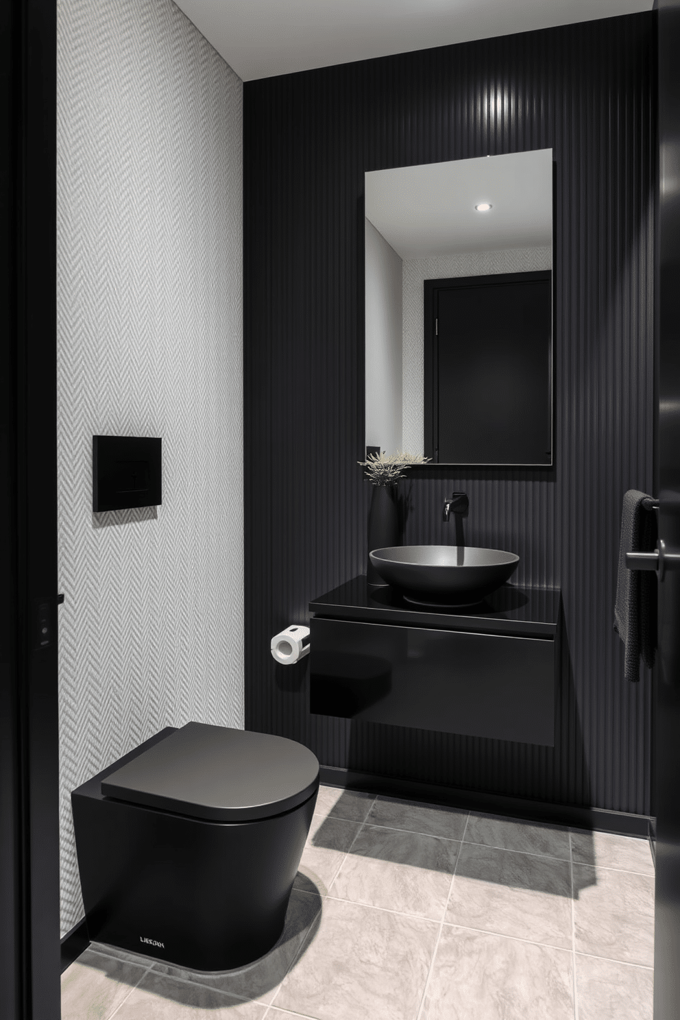 A sleek black powder room features modern black fixtures, including a wall-mounted faucet and a minimalist toilet. The walls are adorned with a textured white wallpaper, providing a subtle contrast to the dark elements. A floating black vanity with a simple, elegant sink sits beneath a large frameless mirror. The floor is finished with large gray tiles, and a small potted plant adds a touch of greenery to the otherwise monochromatic space.