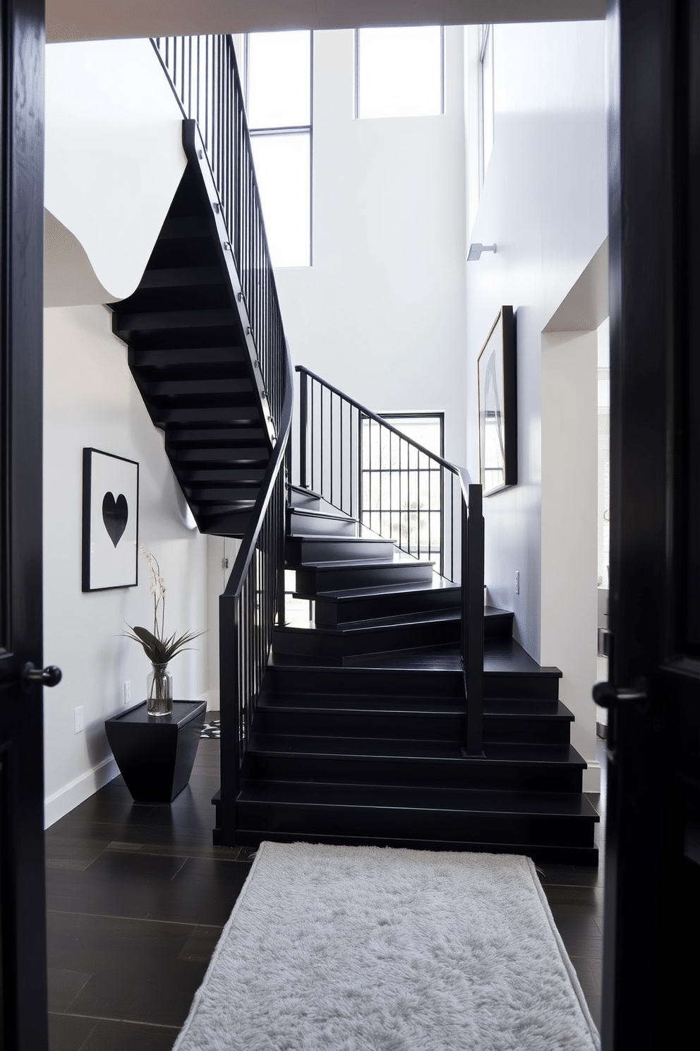 A striking black staircase ascends gracefully against a contrasting white wall, creating a bold visual statement in the entryway. The staircase features sleek, modern railings that enhance its contemporary aesthetic, while the white wall is adorned with minimalist artwork to add a touch of elegance. Natural light floods the space through large windows, highlighting the rich texture of the black steps. A plush runner in a soft gray hue adds warmth underfoot, inviting guests to explore the upper levels of the home.