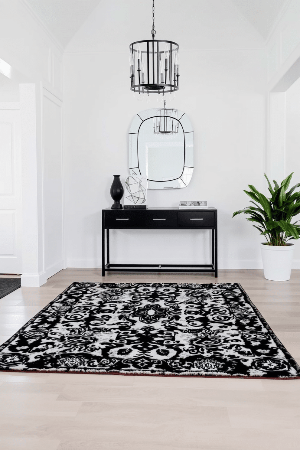 A striking foyer featuring a layered rug arrangement that adds texture and depth to the space. The base layer is a large, neutral-toned area rug, topped with a smaller, intricately patterned black and white rug that creates visual interest. The walls are painted in a crisp white, providing a clean backdrop for the bold design elements. A sleek console table in black finishes sits against the wall, adorned with modern decor and a statement mirror above it, reflecting the elegance of the foyer.