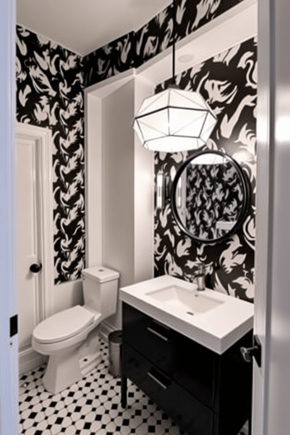 A striking black and white powder room features unique pendant lighting with a geometric design that draws the eye upward. The walls are adorned with bold black and white wallpaper, creating a dramatic backdrop for the sleek, modern fixtures. A minimalist black vanity with a white countertop complements the aesthetic, while a round mirror with a black frame reflects the stylish lighting above. The floor is covered in a chic black and white tile pattern, enhancing the room's contemporary feel.