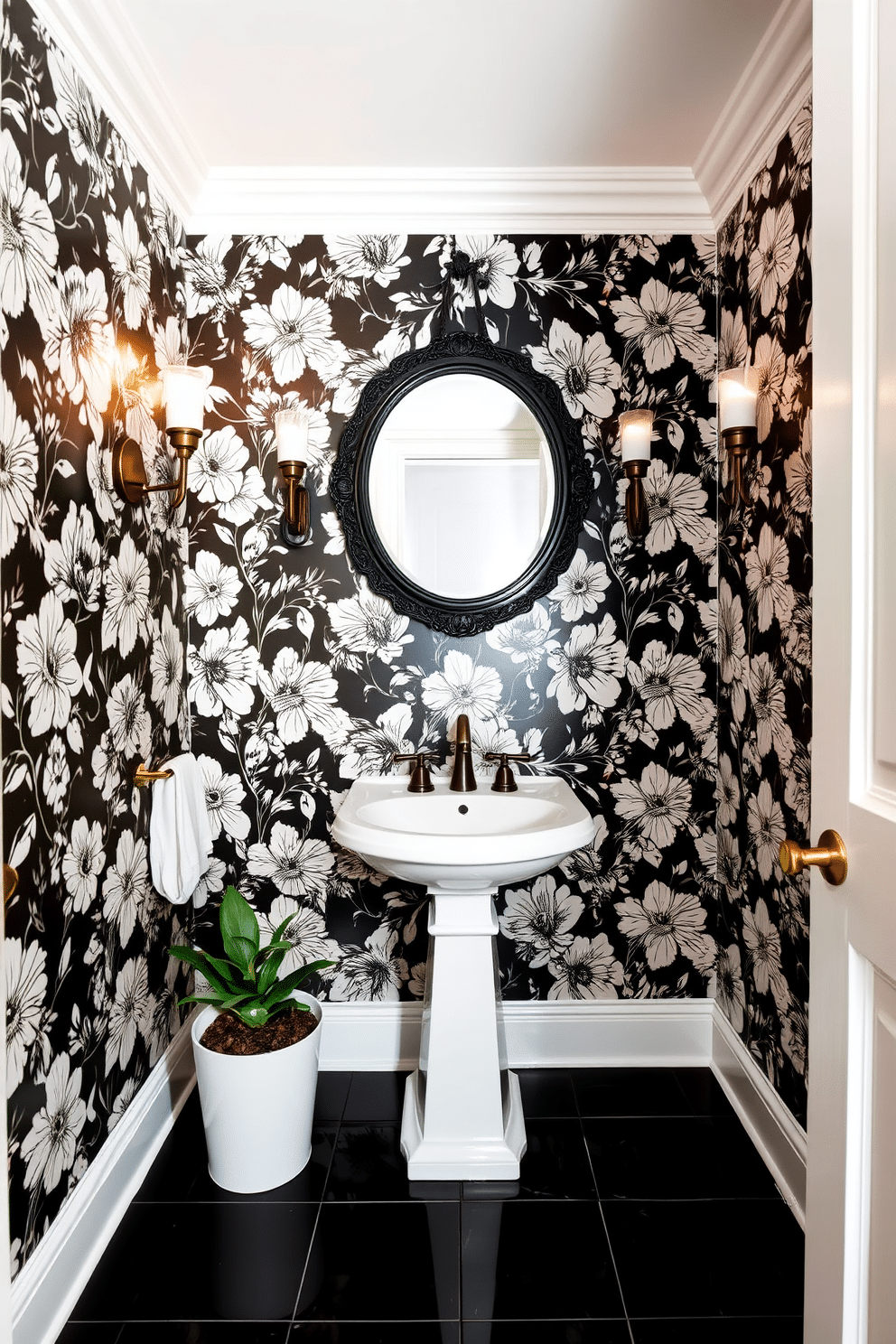 A chic powder room adorned with striking black and white floral wallpaper that creates a bold focal point. The space features a sleek pedestal sink with a vintage-style faucet, complemented by a round mirror with an ornate black frame hanging above it. The floor is covered in glossy black tiles that contrast beautifully with the wallpaper, while a small potted plant adds a touch of greenery to the decor. Elegant wall sconces provide warm lighting, enhancing the sophisticated ambiance of this stylish retreat.