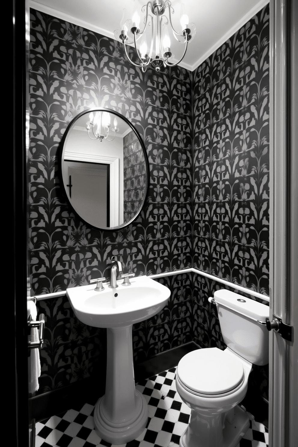 A chic black and white powder room features an elegant wallpaper with a striking geometric pattern that draws the eye. The space is complemented by a sleek pedestal sink and a round mirror with a black frame, creating a stylish focal point. The walls are adorned with the bold wallpaper, while the floor showcases classic black and white checkerboard tiles. A small, modern chandelier hangs from the ceiling, adding a touch of glamour to the compact area.