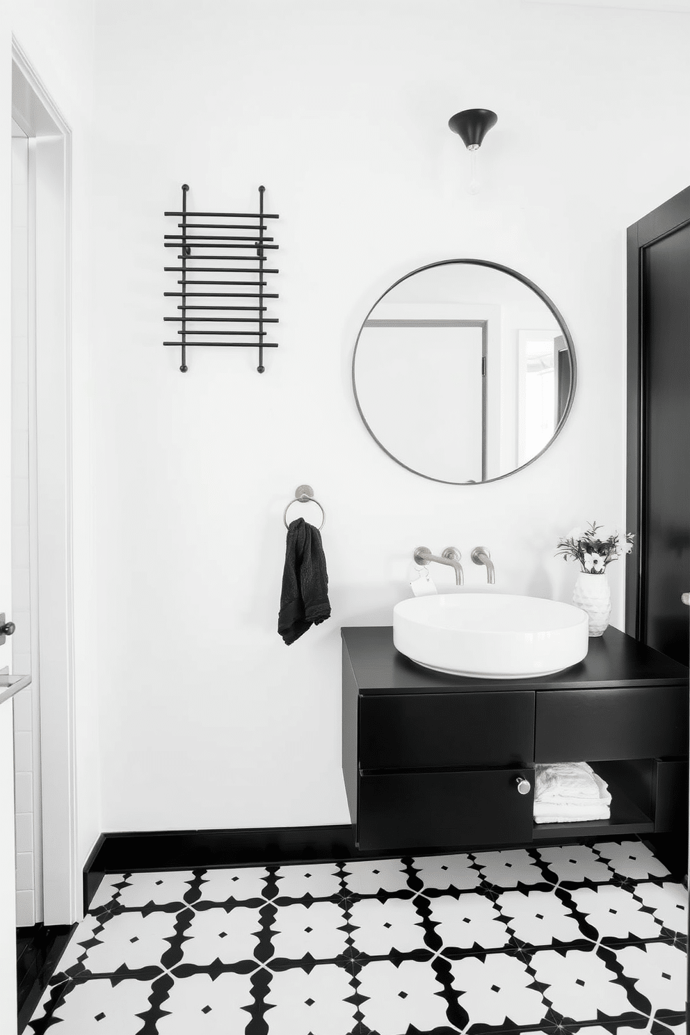 A stylish wall-mounted black towel rack is elegantly positioned against a crisp white wall, providing a modern touch to the space. Below, a sleek black and white patterned tile floor complements the overall aesthetic, creating a harmonious contrast. The powder room features a minimalist black vanity with a white vessel sink, accented by chic gold fixtures. A large round mirror hangs above the vanity, reflecting the stylish décor and enhancing the room's sense of space.