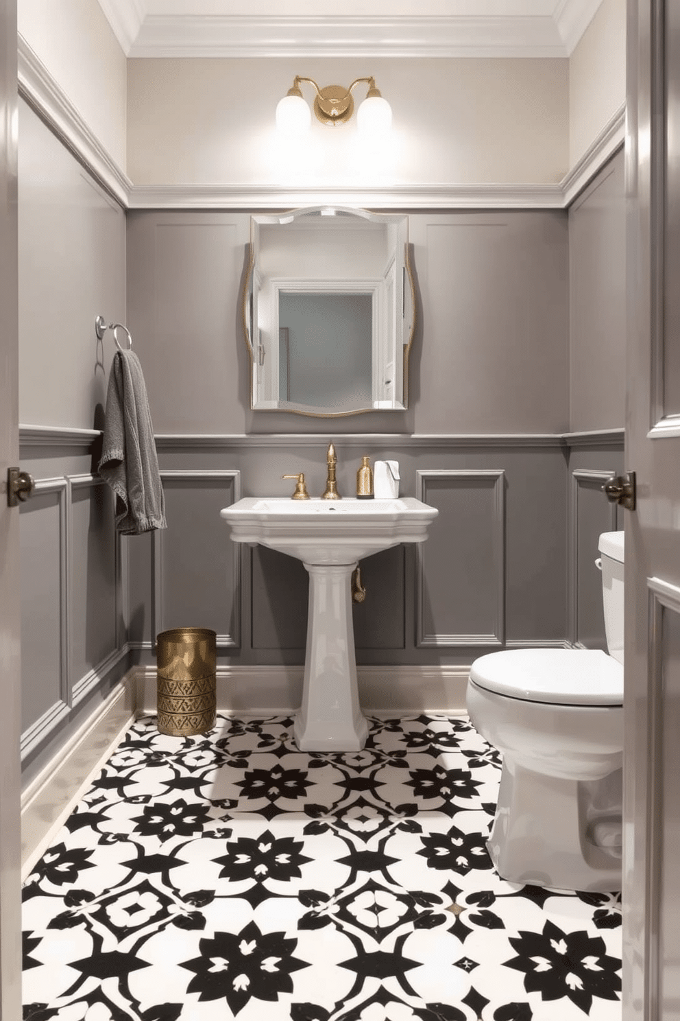 A chic powder room features stylish patterned floor tiles in black and white, creating a striking contrast. The walls are adorned with elegant wainscoting, painted in a soft gray hue, enhancing the room's sophistication.