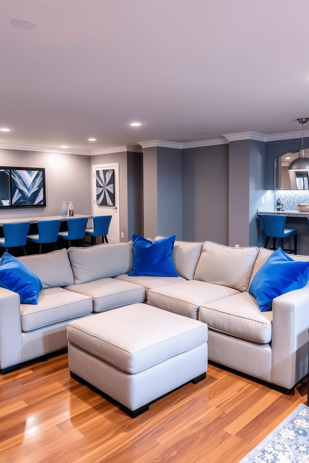 A cozy blue basement retreat features plush blue throw pillows scattered across a deep sectional sofa, inviting relaxation and comfort. The walls are painted a soft gray, while ambient lighting creates a warm and inviting atmosphere, perfect for entertaining or unwinding. Incorporate a stylish bar area with a sleek countertop and high stools, seamlessly blending functionality with design. The flooring is a rich hardwood, providing a striking contrast to the blue accents and enhancing the overall aesthetic of the space.