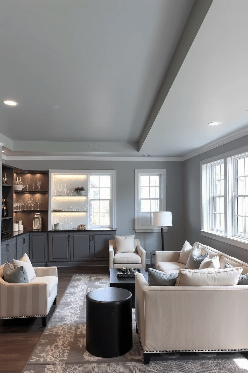 A serene basement retreat featuring a light blue ceiling that enhances the airy atmosphere of the space. The walls are painted in a soft gray, complemented by plush seating in neutral tones and a stylish area rug that adds warmth. In one corner, a sleek bar area showcases elegant shelving with decorative glassware and ambient lighting. Large windows allow natural light to filter in, creating a welcoming environment perfect for relaxation and entertainment.