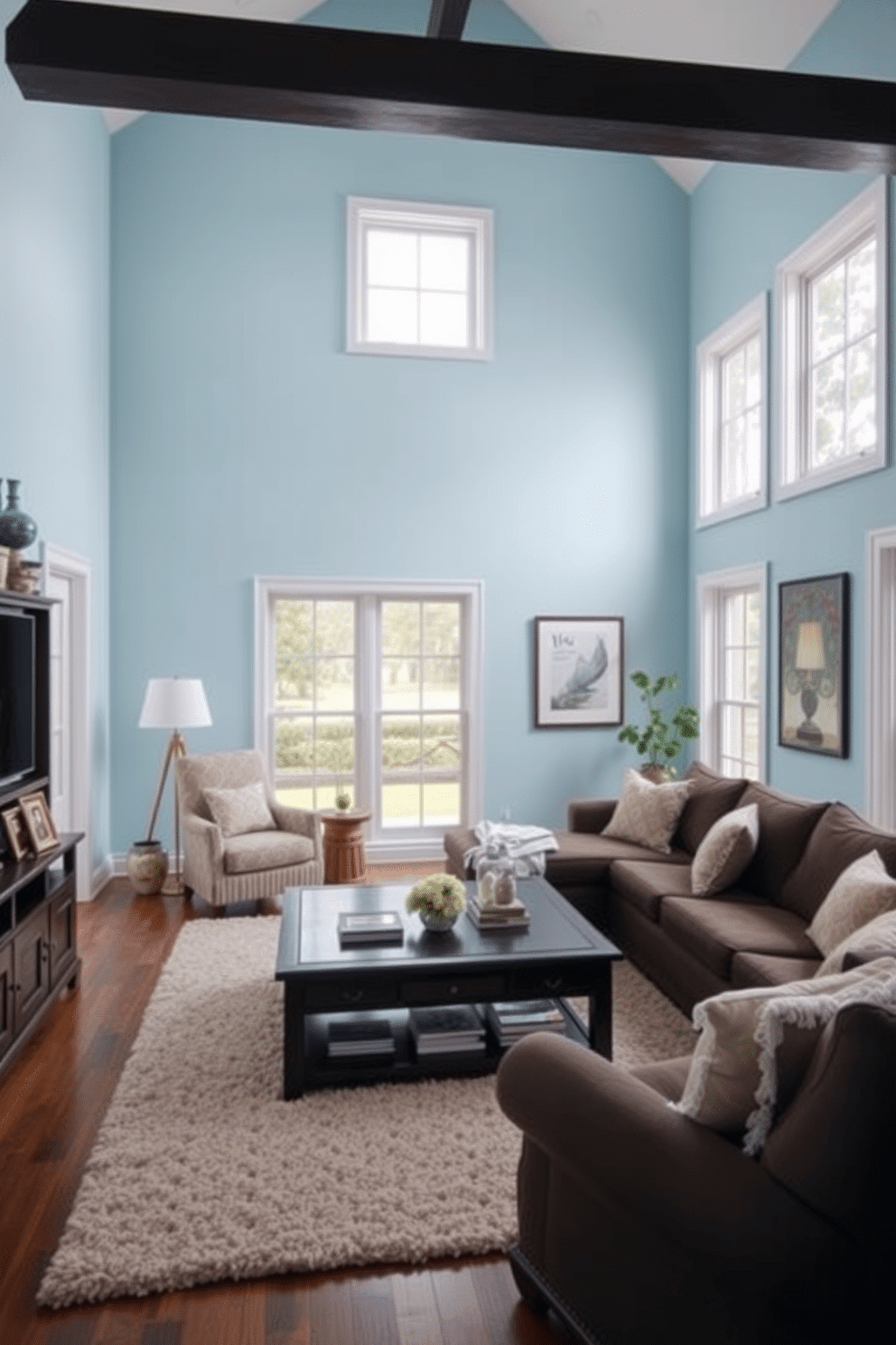 A cozy family room featuring light blue walls that create a serene atmosphere. The space is furnished with dark wood furniture, including a large coffee table and a comfortable sectional sofa, providing a perfect contrast to the wall color. Large windows allow natural light to flood the room, enhancing the airy feel. Accents like soft throw pillows and a plush area rug add warmth and texture to the design.