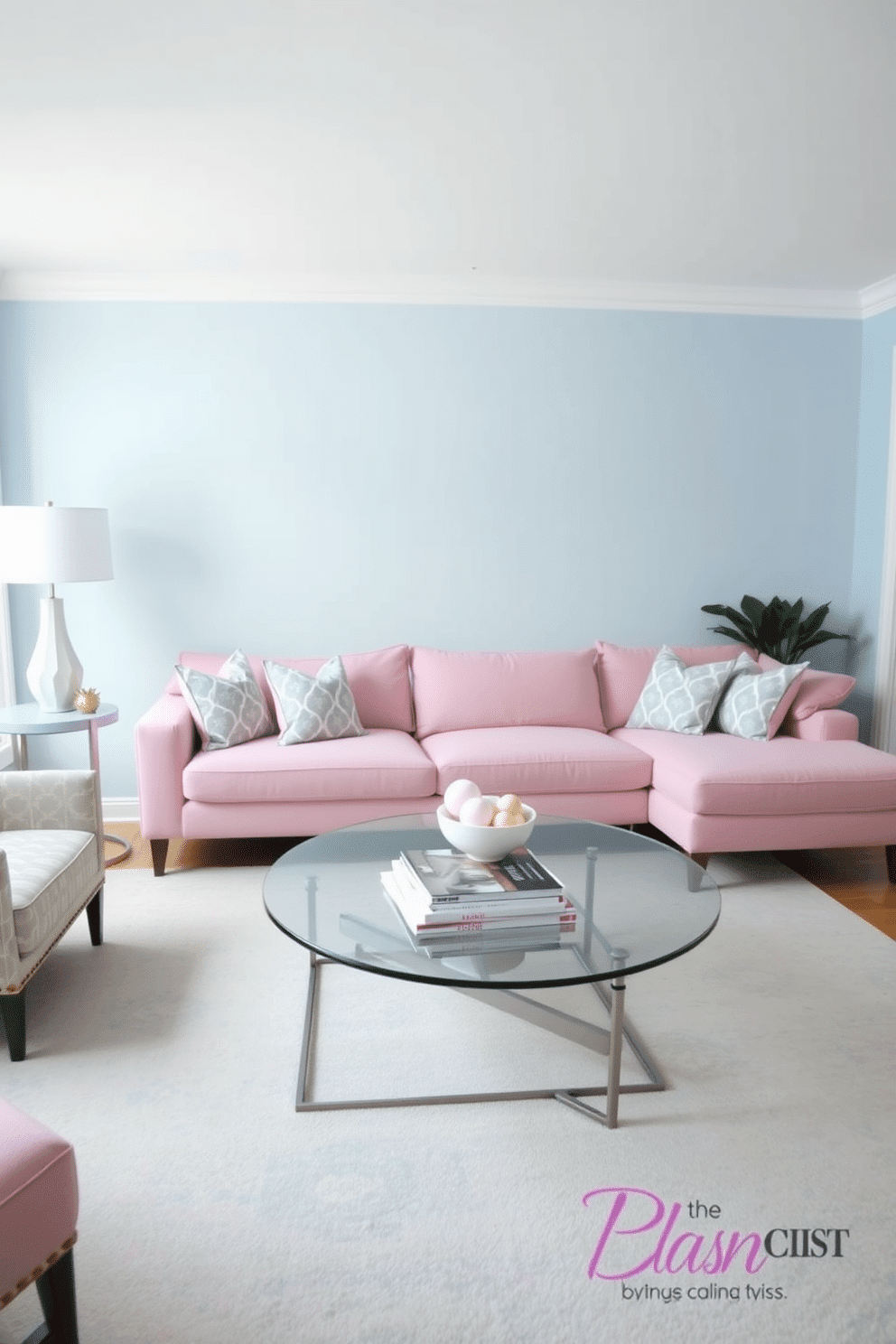 A cozy family room designed in a blue and pink pastel theme. The walls are painted a soft pastel blue, complemented by a plush pink sectional sofa adorned with patterned throw pillows. A large area rug in subtle shades of blue and pink anchors the seating area. A sleek coffee table sits in the center, topped with a stack of design magazines and a decorative bowl of pastel-colored accents.