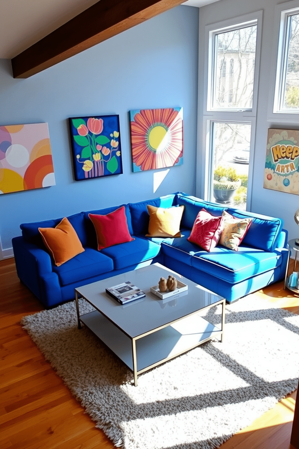 A bold blue sectional sofa takes center stage in a spacious family room, complemented by vibrant artwork that adorns the walls. The room features large windows that allow natural light to flood in, enhancing the cheerful atmosphere. A sleek coffee table sits in front of the sectional, surrounded by colorful accent pillows that add a playful touch. The flooring is a warm hardwood, and a plush area rug anchors the seating area, creating a cozy and inviting space for family gatherings.