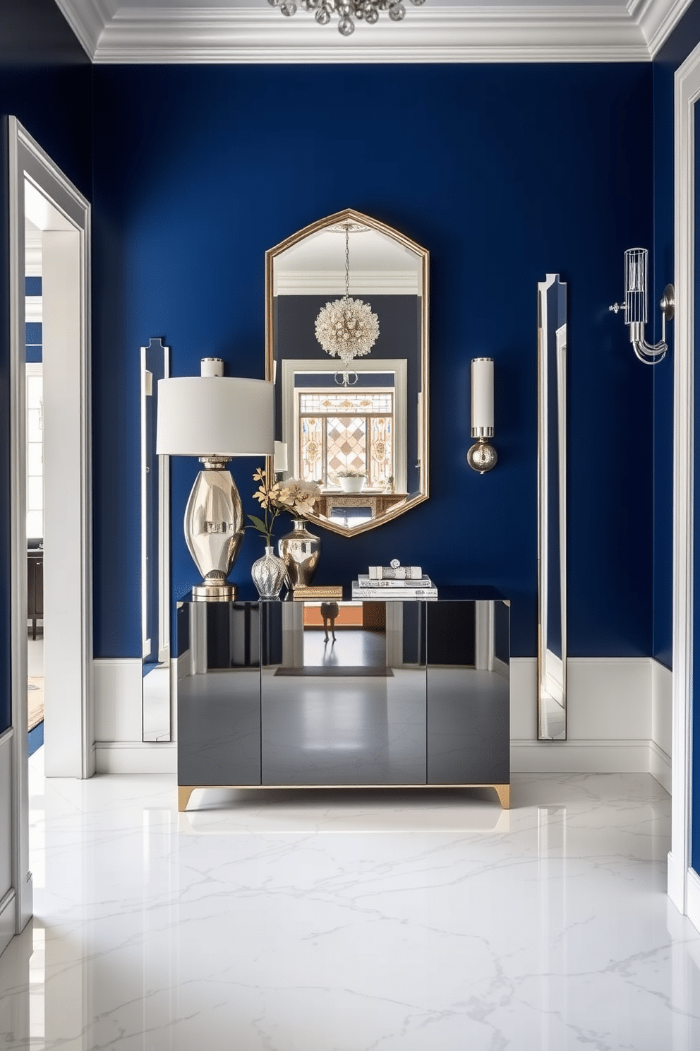 A stunning foyer featuring deep sapphire blue walls that create a dramatic entrance. Mirrored furniture reflects the light, enhancing the space's elegance and sophistication. The floor is adorned with a luxurious white marble, providing a striking contrast to the bold wall color. A sleek console table with a glossy finish is placed against the wall, topped with an eye-catching arrangement of decorative items and a statement lamp.