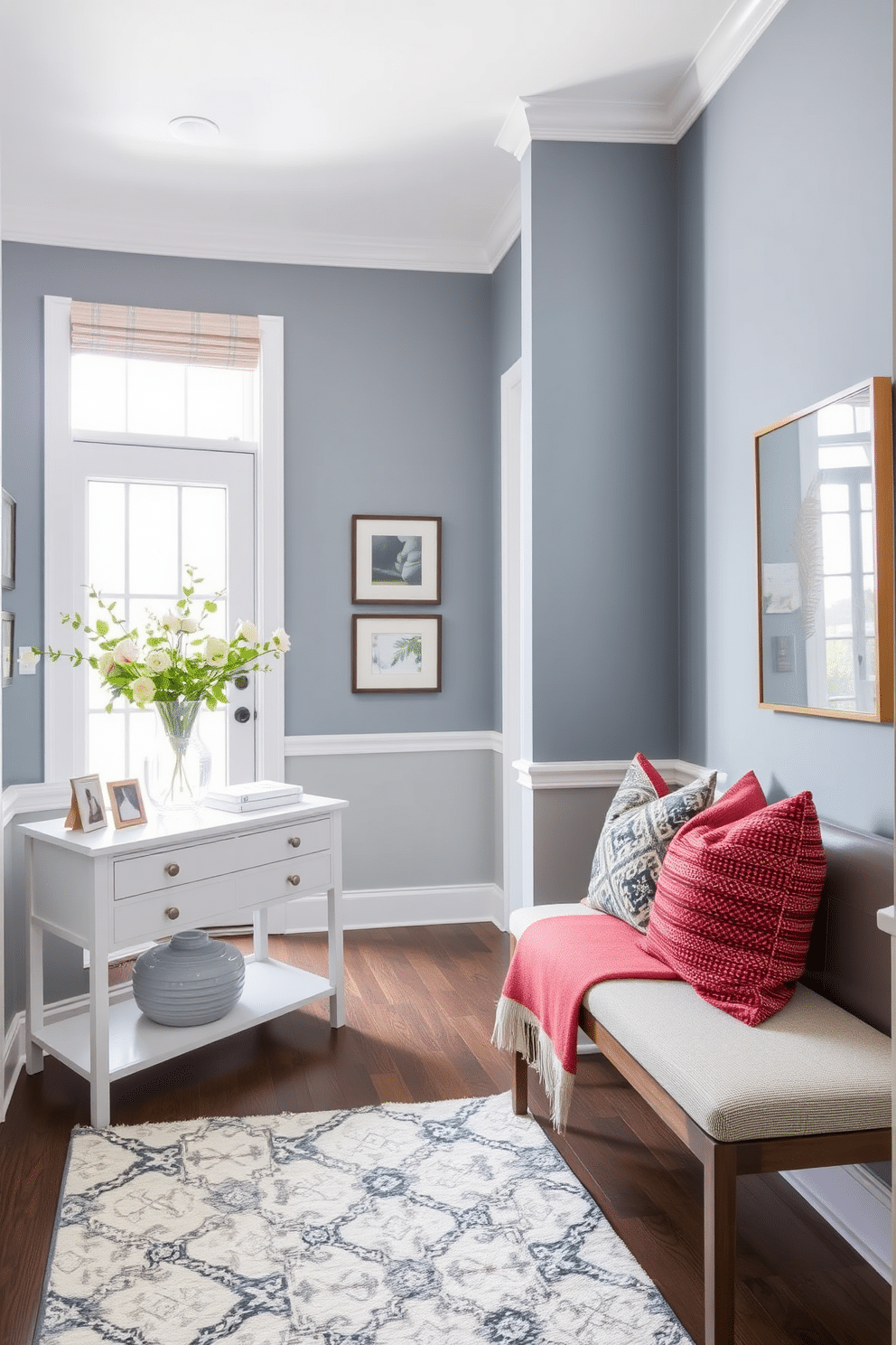 A serene foyer featuring subtle slate blue walls that create a calming atmosphere. The space is adorned with cozy textiles, including a plush area rug and decorative throw pillows on a stylish bench. Natural light filters through a large window, illuminating a curated selection of artwork on the walls. A chic console table, topped with a vase of fresh flowers, adds an inviting touch to the entryway.