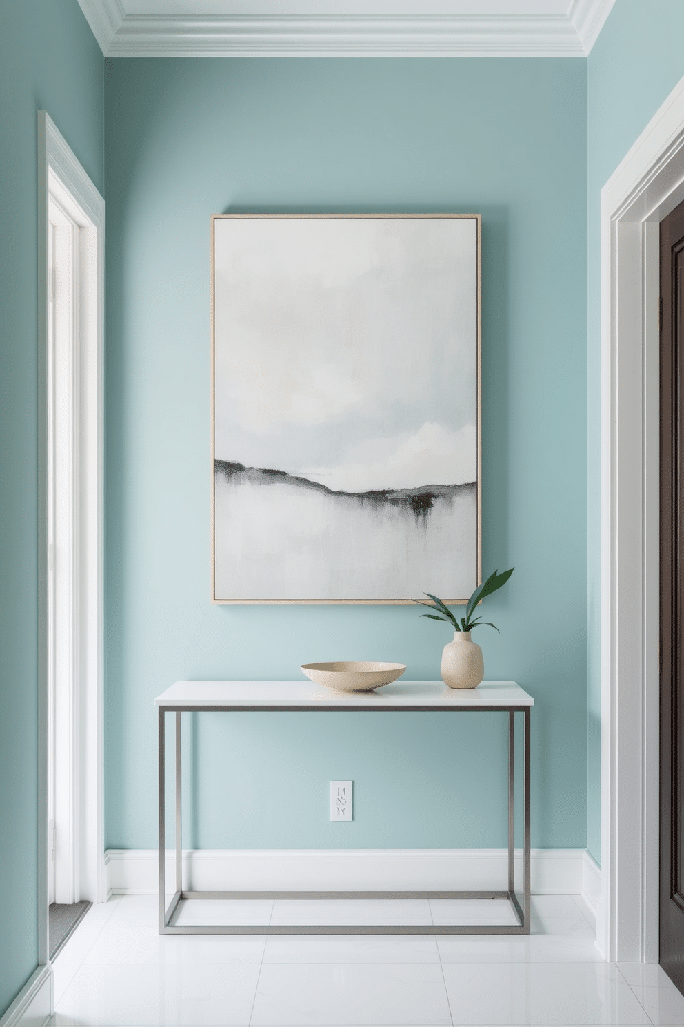 A serene foyer featuring calming teal walls adorned with soothing abstract artwork that evokes tranquility. The space includes a sleek console table with a minimalist design, topped with a small potted plant and a decorative bowl.