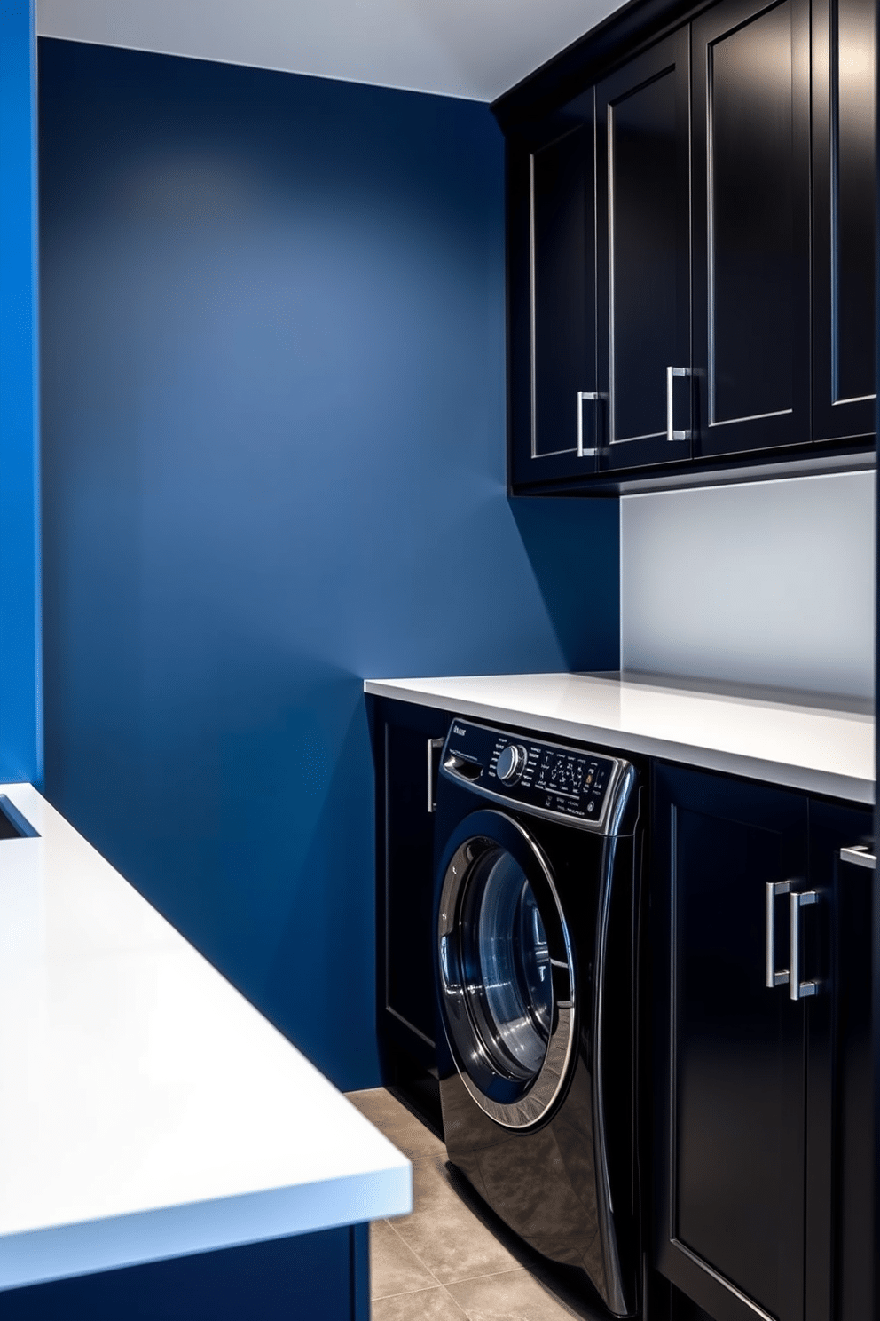 A contemporary laundry room featuring a striking contrast of blue and black. The walls are painted a deep navy blue, while sleek black cabinetry provides a modern touch and ample storage space. A large, white countertop stretches across the room, offering a functional workspace for folding clothes. A stylish black washer and dryer set is seamlessly integrated into the cabinetry, enhancing the room's cohesive design.