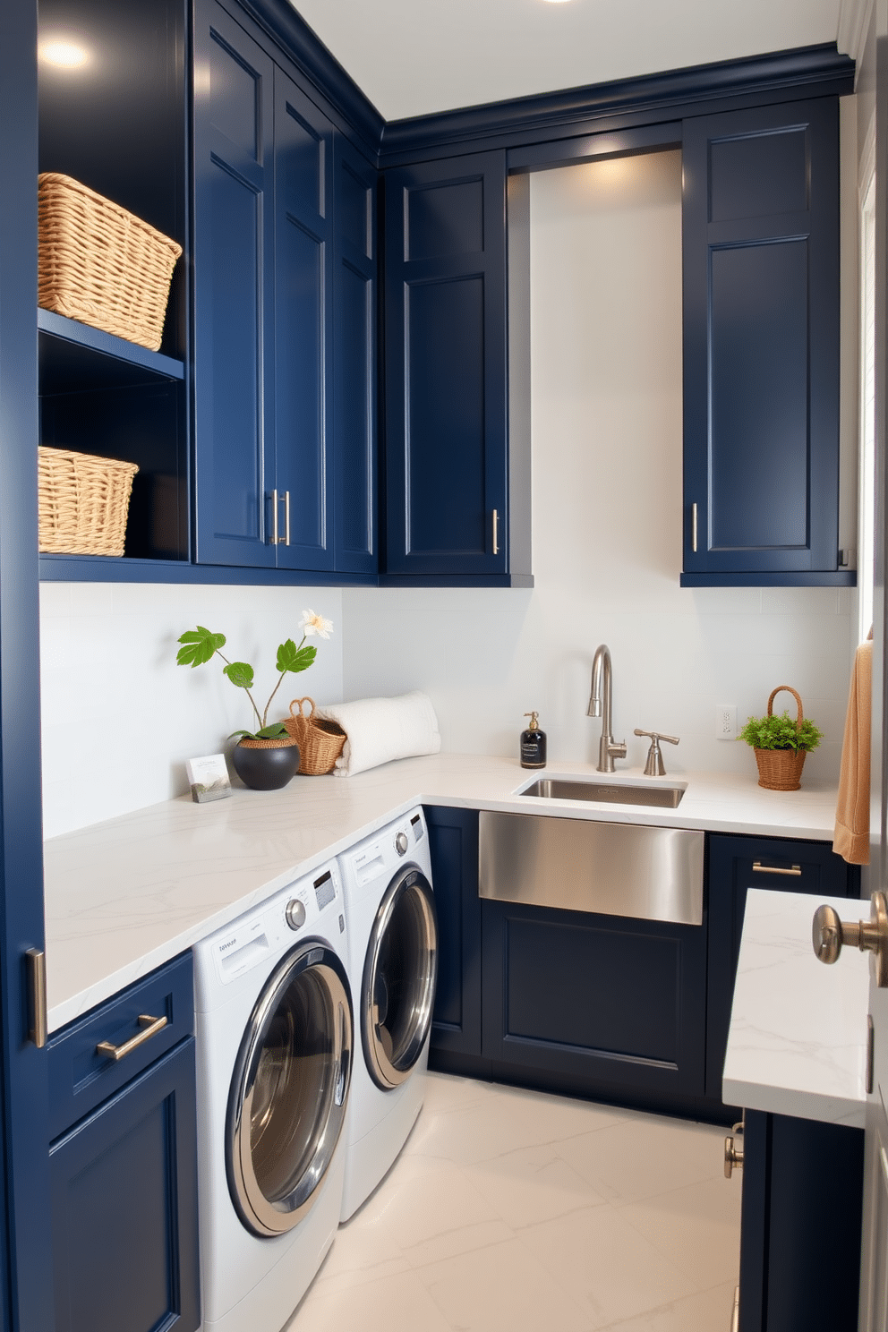 A bright and airy laundry room features navy blue cabinets that provide a striking contrast against the crisp white walls. The marble countertops add a touch of elegance, creating a functional space perfect for laundry tasks. The room is equipped with a large stainless steel sink, ideal for soaking and rinsing clothes. Decorative elements such as woven baskets and potted plants enhance the inviting atmosphere while keeping the space organized.