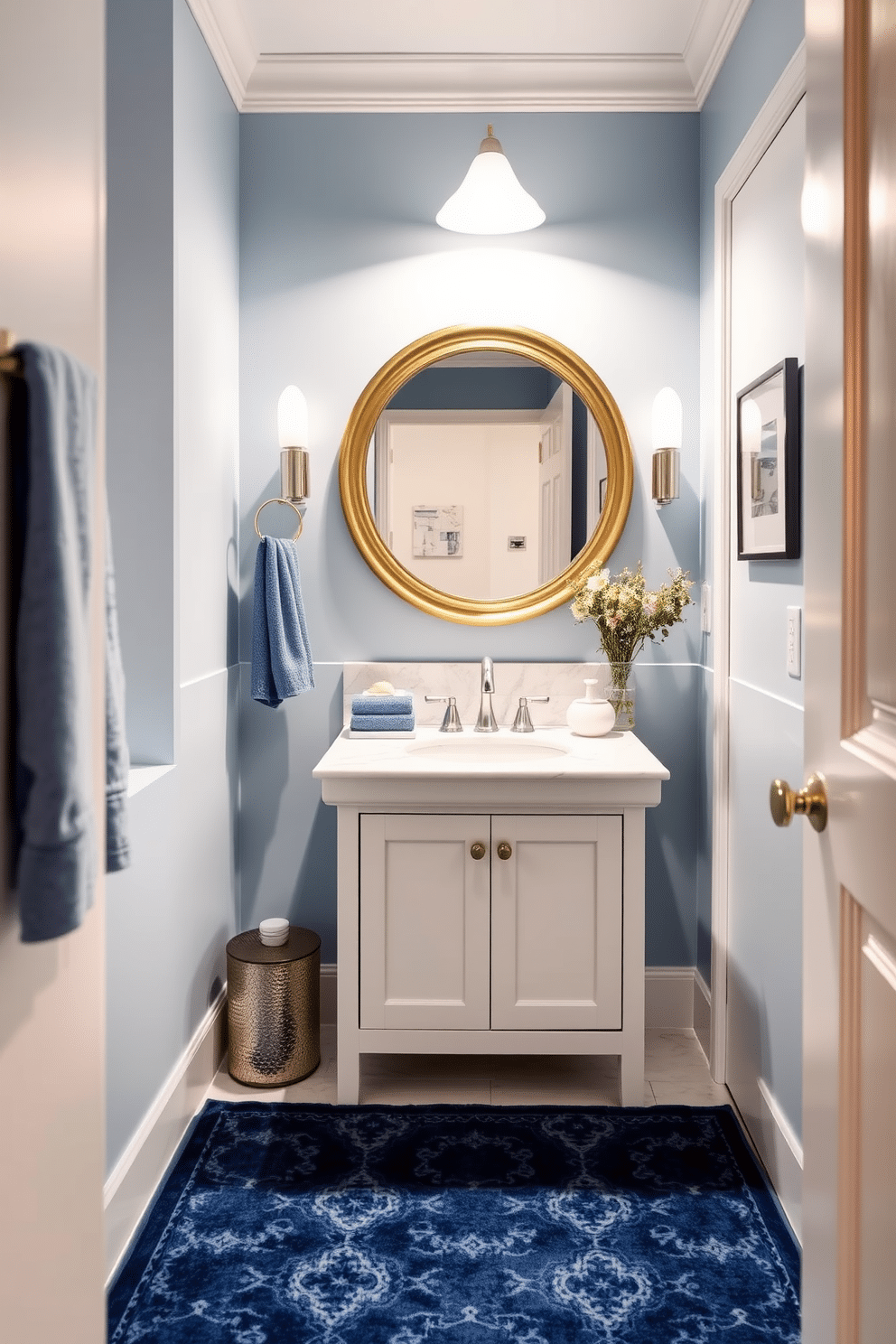 A stylish blue rug is placed in a cozy powder room, enhancing the comfort and aesthetic appeal of the space. The rug features intricate patterns that complement the soft blue walls and elegant fixtures. The powder room showcases a chic design with a sleek white vanity topped with a polished marble surface. A round mirror with a brushed gold frame hangs above the vanity, reflecting the charming ambiance created by the blue accents.