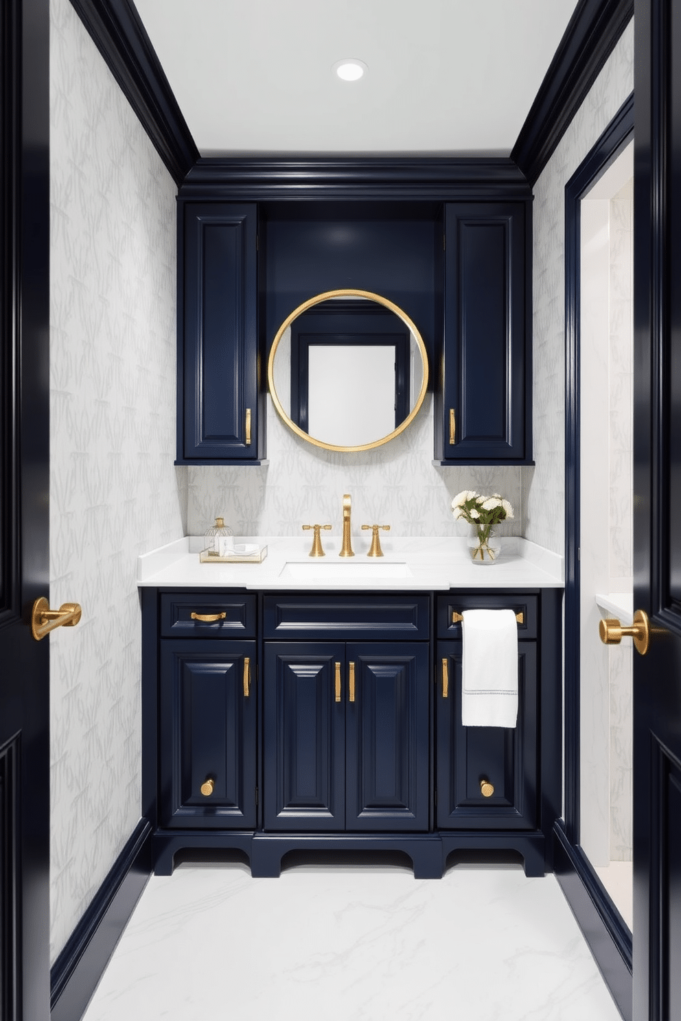 Custom cabinetry in a deep navy hue creates a striking focal point in this elegant powder room. The cabinetry features intricate detailing, complemented by gold hardware that adds a touch of luxury. The walls are adorned with a soft, light gray wallpaper, enhancing the richness of the navy cabinetry. A round mirror with a gold frame hangs above a sleek white sink, creating a balanced and sophisticated look.