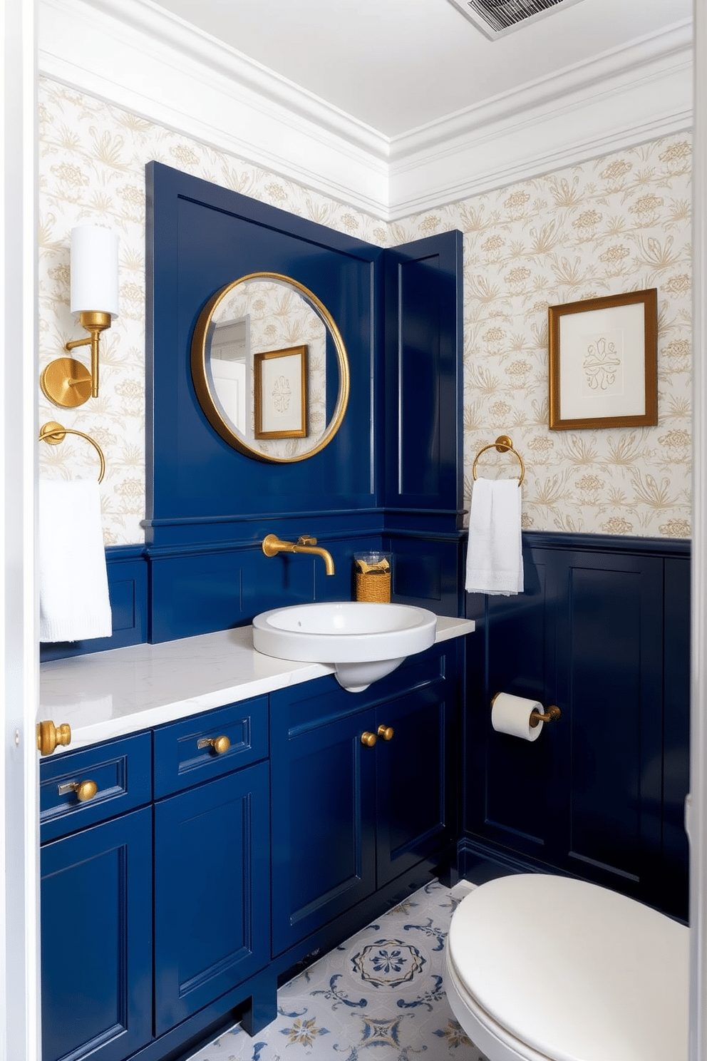 A striking blue powder room features rich navy cabinetry that contrasts beautifully with polished brass fixtures. The cabinetry is complemented by a sleek white countertop, enhancing the overall elegance of the space. The walls are adorned with a delicate wallpaper pattern in soft gold tones, adding a touch of luxury. A round mirror with a brass frame hangs above a stylish pedestal sink, creating a focal point in the room.