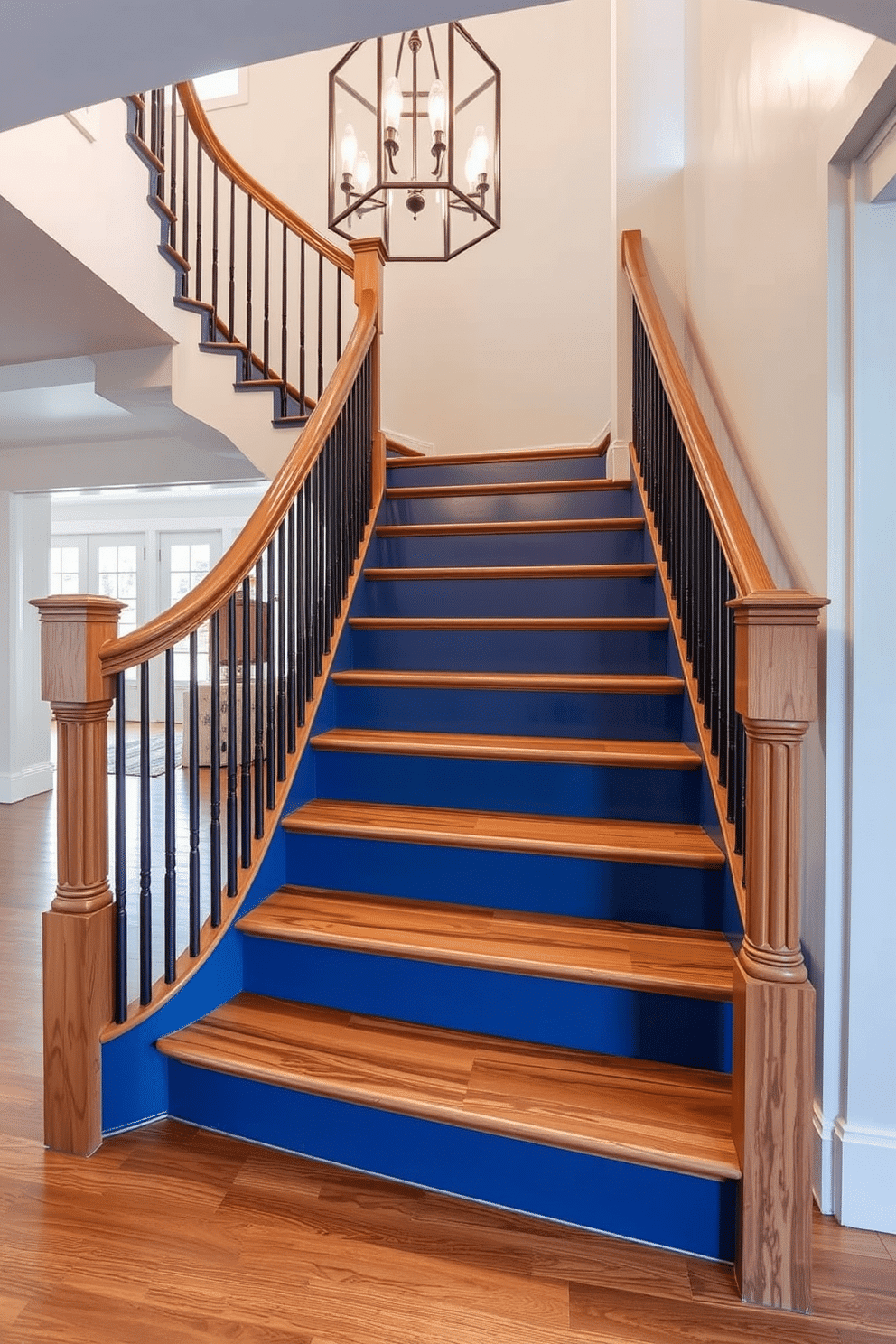 A stunning staircase featuring painted blue risers that contrast beautifully with rich natural wood treads. The staircase is illuminated by a modern chandelier above, creating an inviting focal point in the entryway.