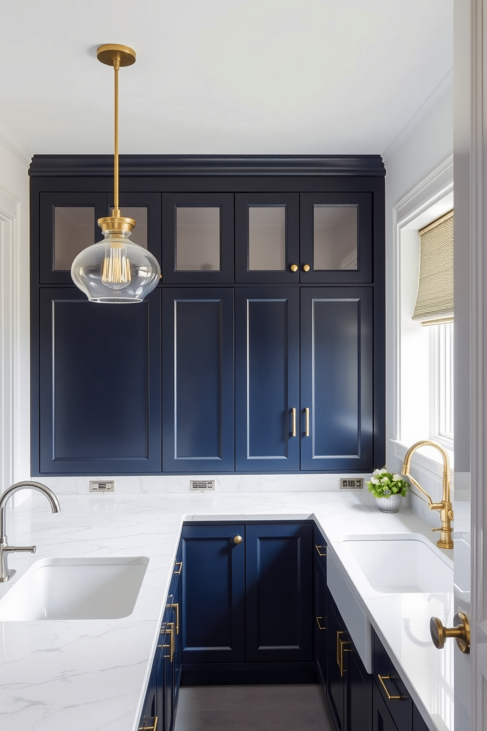 A chic butler pantry featuring stylish pendant lighting suspended above the counters. The cabinetry is a deep navy blue, complemented by brass hardware and a white marble countertop that adds elegance to the space.