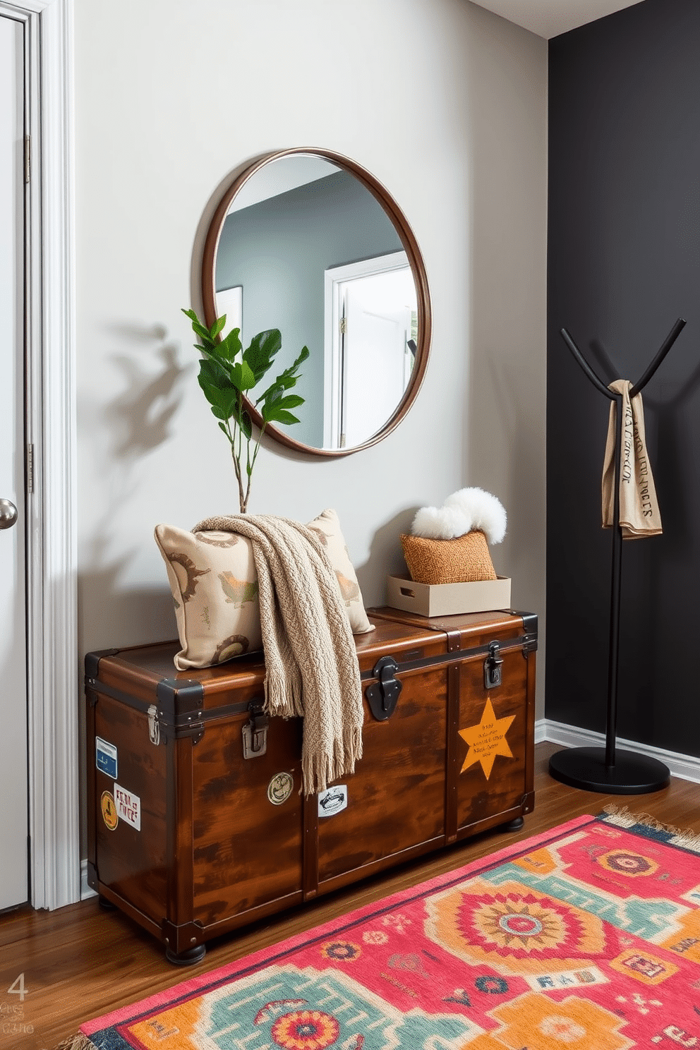 A vintage trunk serves as a unique storage solution, adding character and charm to the space. It is placed against a wall, adorned with travel stickers, and topped with a cozy throw and decorative pillows for an inviting touch. The condo entryway features a sleek console table with a rich wood finish, paired with a large round mirror that reflects light and creates a sense of openness. A stylish coat rack stands nearby, complemented by a vibrant area rug that adds warmth and personality to the entrance.