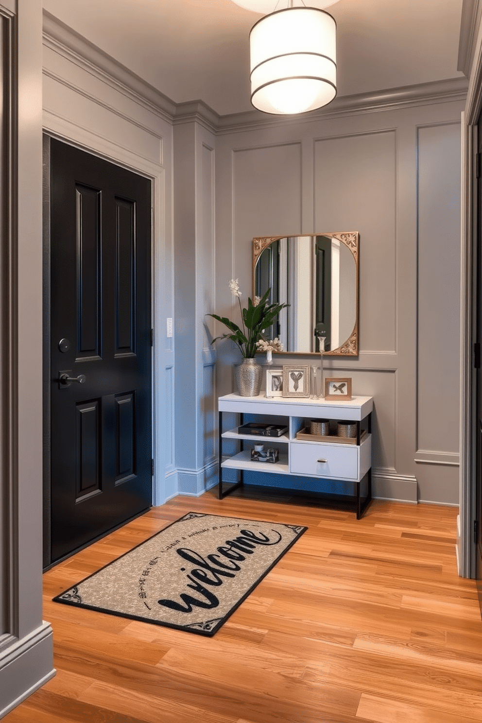 A stylish entryway welcomes guests with a personalized welcome mat featuring a custom design that reflects the homeowner's personality. The walls are adorned with light gray paneling, and a sleek console table with decorative accessories sits beside the door, creating an inviting atmosphere. Bright pendant lighting hangs from the ceiling, illuminating the space while casting a warm glow on the polished hardwood floor. A small potted plant adds a touch of greenery, enhancing the overall aesthetic of the condo entryway.