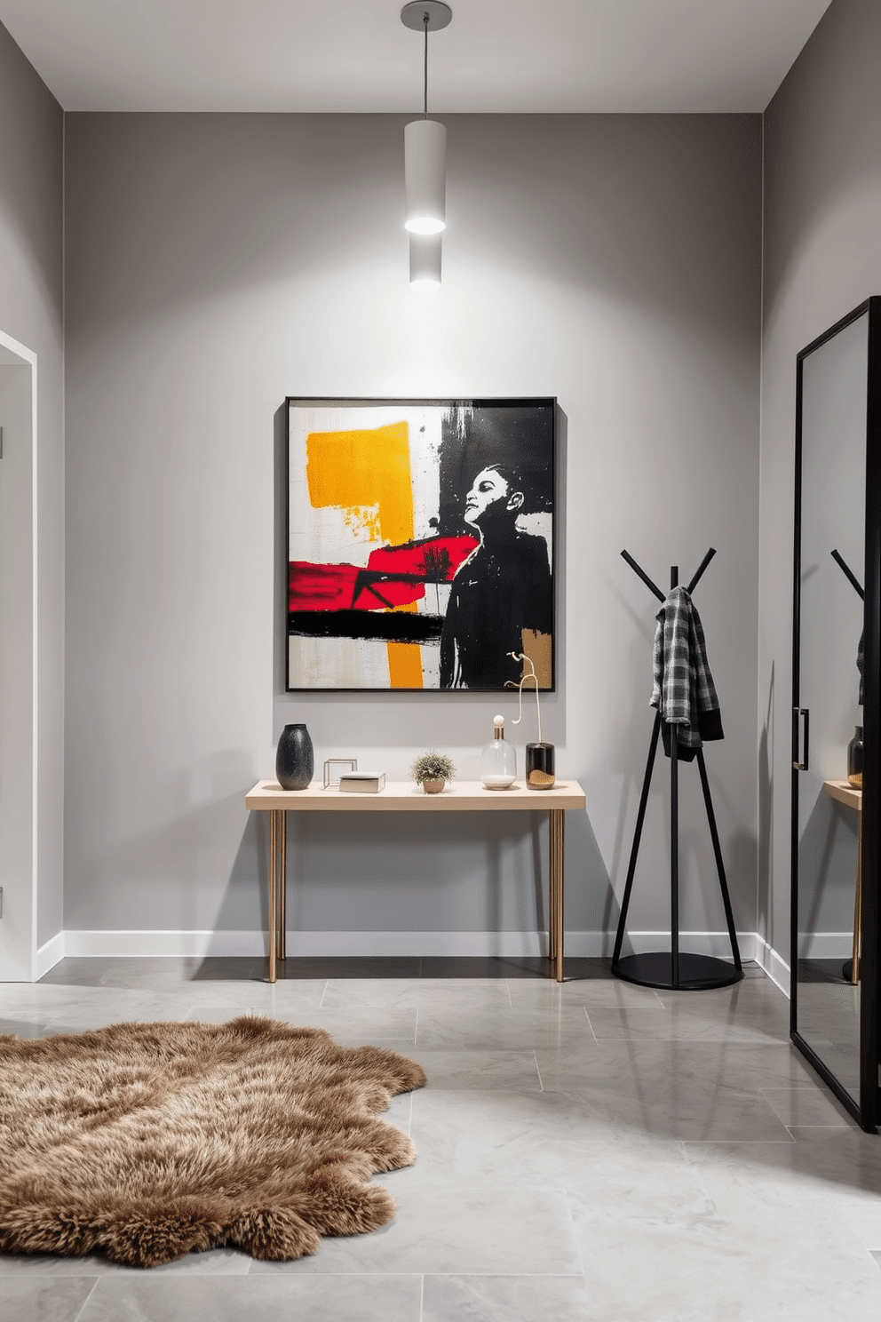 A modern entryway featuring a striking abstract art piece as the focal point, positioned on the main wall. The space is illuminated by sleek pendant lighting, with a minimalist console table beneath the artwork, adorned with decorative objects and a small plant. The flooring is a polished concrete, complemented by a plush area rug that adds warmth to the contemporary design. To the side, a stylish coat rack and a full-length mirror enhance functionality while maintaining a clean, modern aesthetic.