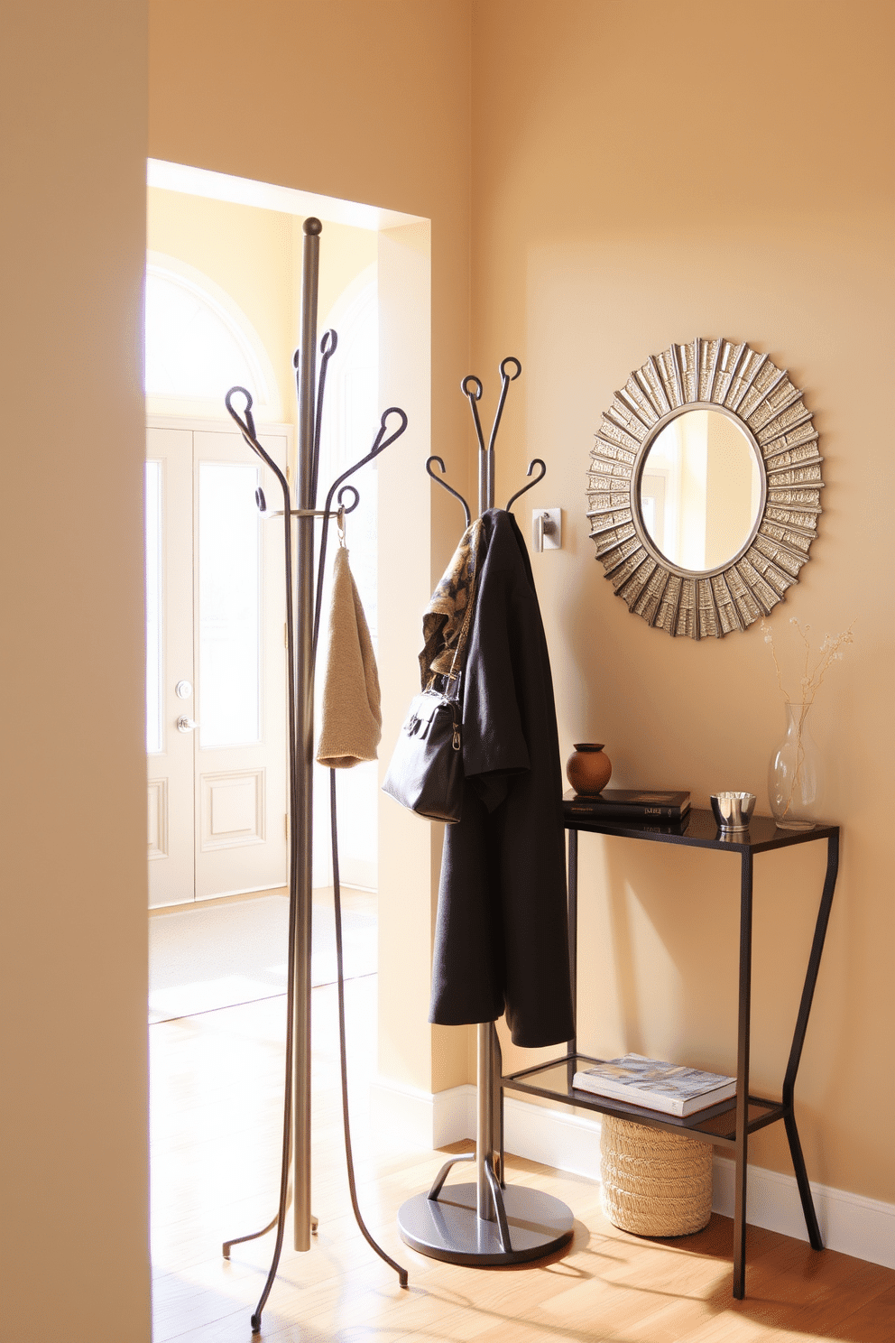 A stylish coat rack stands elegantly near the entrance, crafted from sleek metal with a minimalist design. It features multiple hooks for hanging coats and bags, complementing the modern aesthetic of the space. The entryway is adorned with a warm, inviting color palette, featuring a soft beige wall that enhances natural light. A small console table sits beneath a decorative mirror, providing a functional yet stylish area for keys and small accessories.