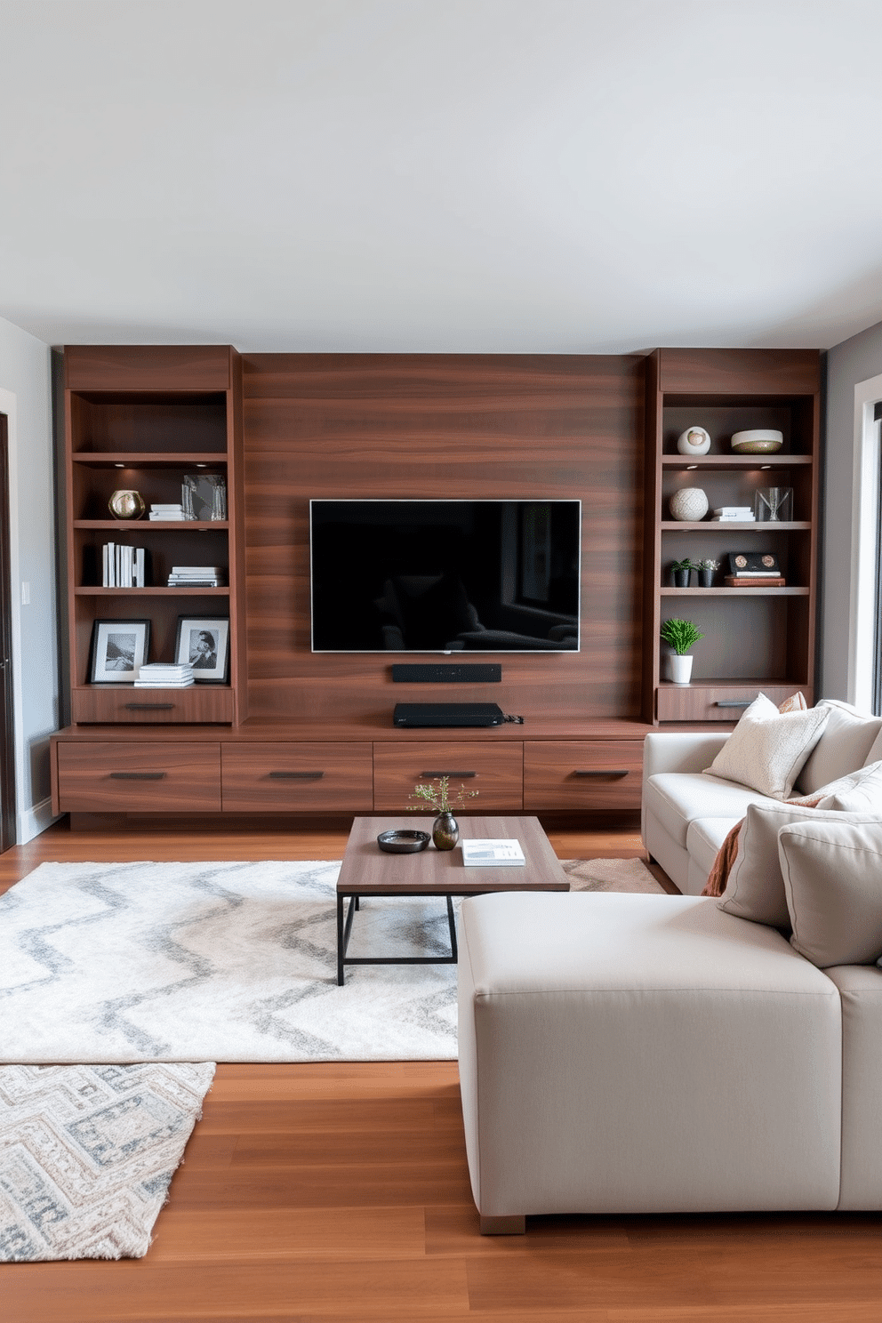 A modern entertainment center showcases a sleek design with a minimalist aesthetic, featuring a low-profile media console in a rich walnut finish. Above the console, a large flat-screen TV is mounted, flanked by stylish floating shelves displaying curated decor items. The family room is designed for comfort and style, with a plush sectional sofa in a neutral fabric arranged around a chic coffee table. Large windows allow natural light to flood the space, complemented by soft area rugs that add warmth and texture to the hardwood floor.