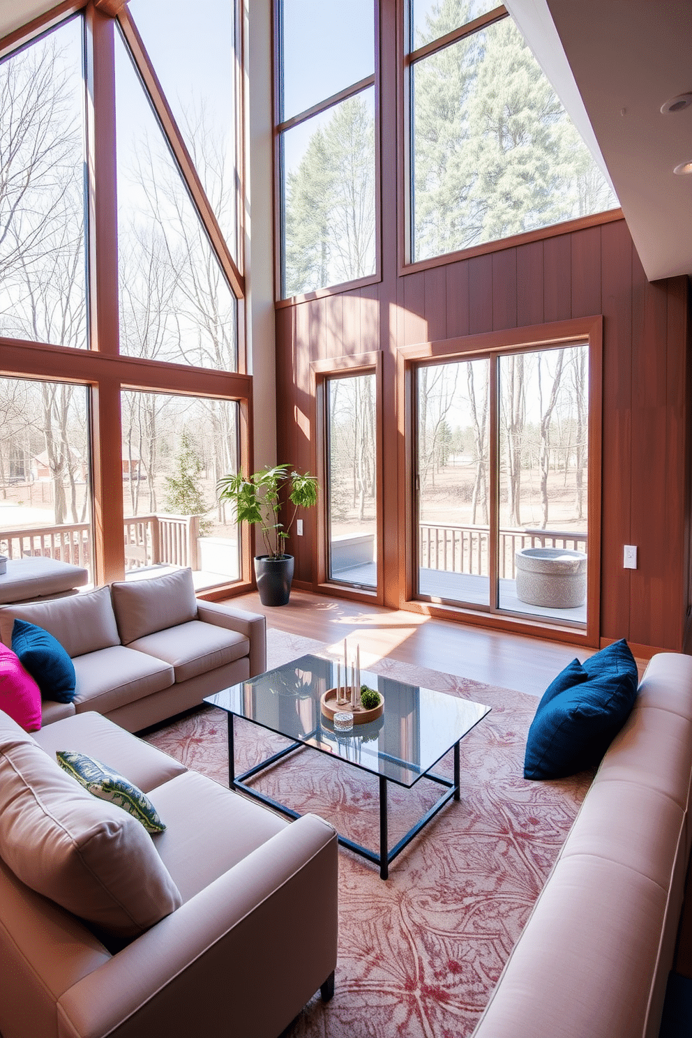 A contemporary family room featuring floor-to-ceiling windows that flood the space with natural light. The room is adorned with a plush sectional sofa in a neutral tone, complemented by vibrant throw pillows and a sleek glass coffee table at the center.